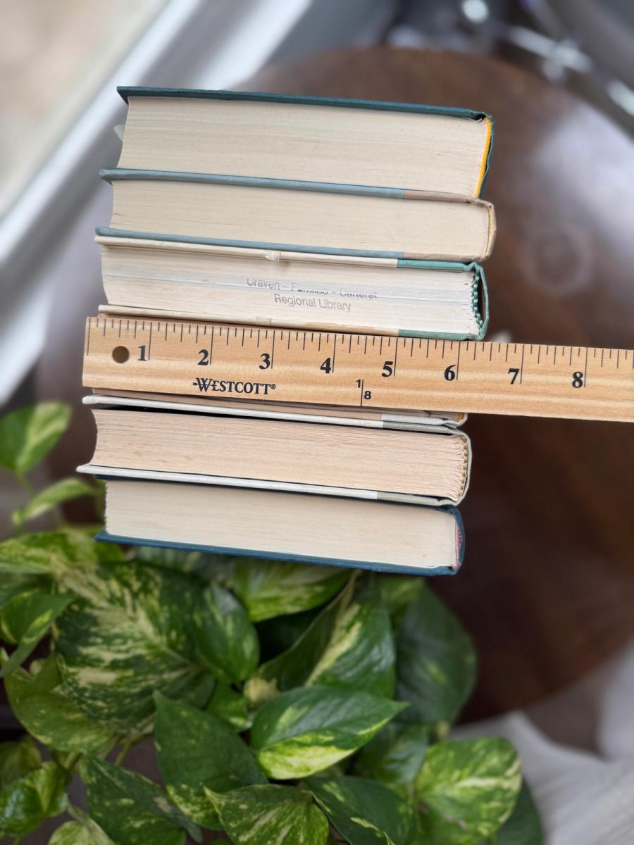 Curated collection of white, pale blue, sand, and soft coastal-neutral books with an airy, sun-faded look.