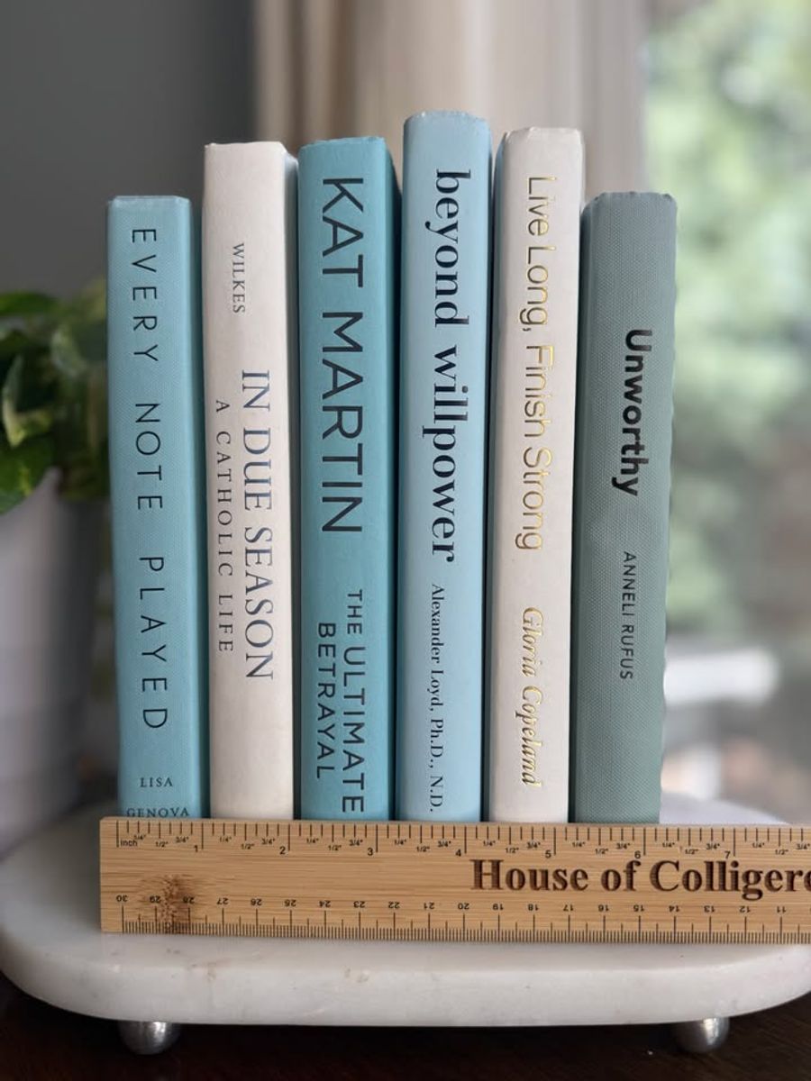 Curated collection of soft blue, aqua, seafoam, and muted coastal-toned books.