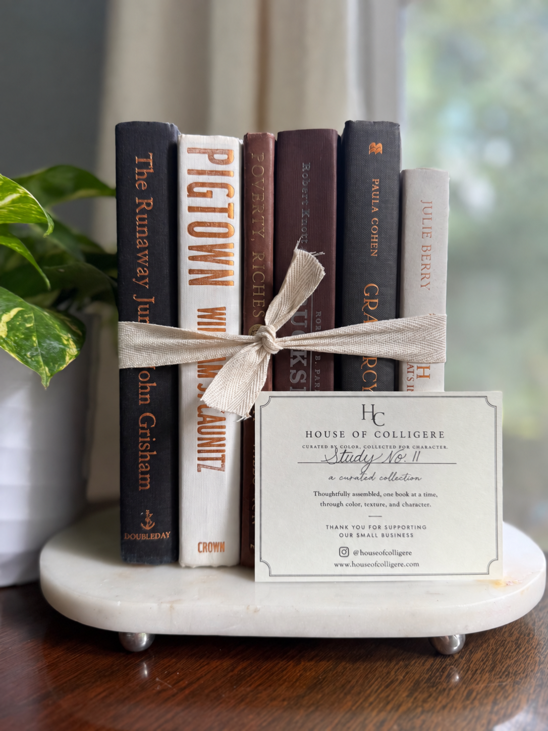 Curated collection of warm brown, olive, tan, and aged neutral books with a traditional library palette.