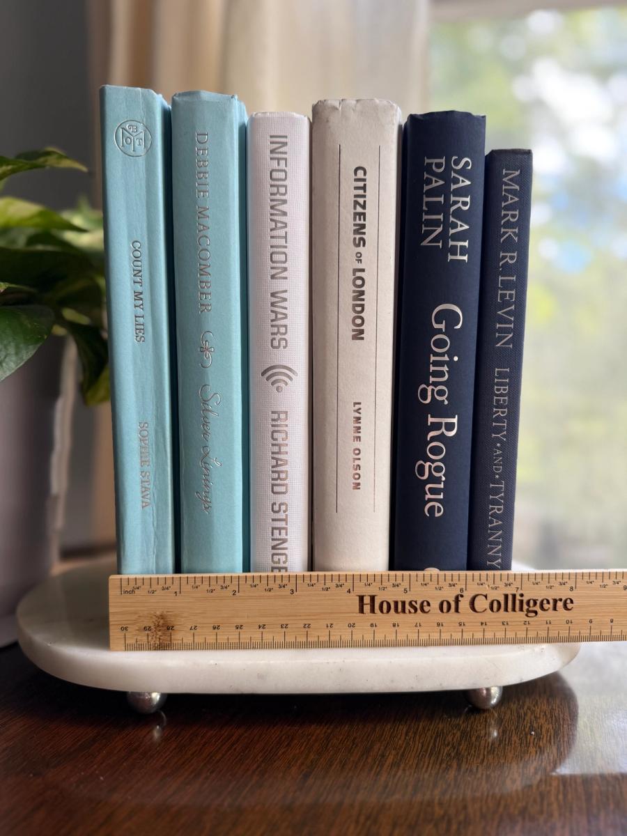 Curated collection of layered blue books ranging from pale coastal blue to deeper ocean tones.