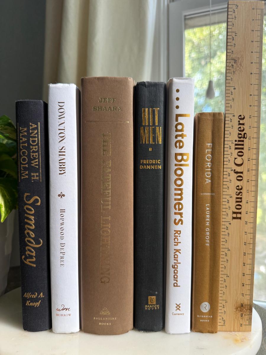 Curated collection of warm brown, olive, tan, and aged neutral books with a traditional library palette.