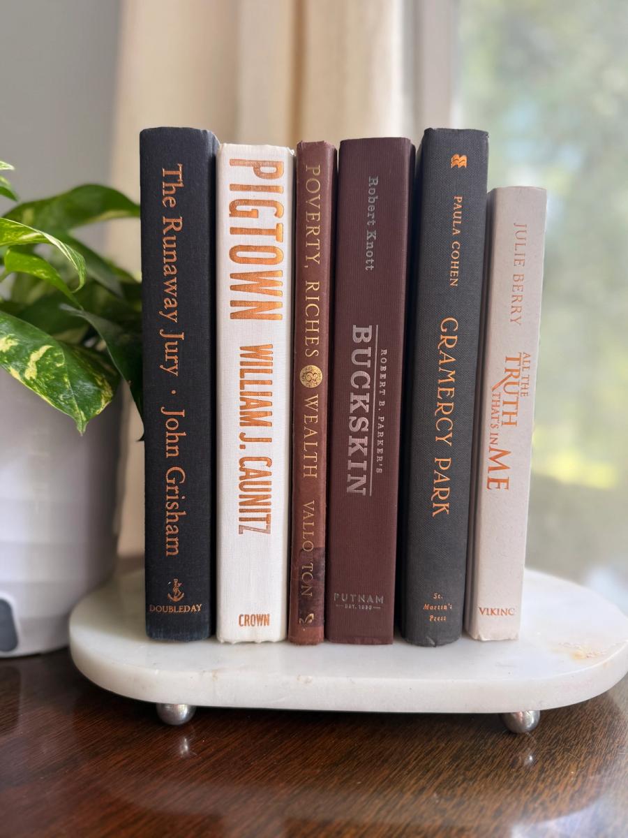 Curated collection of warm brown, olive, tan, and aged neutral books with a traditional library palette.