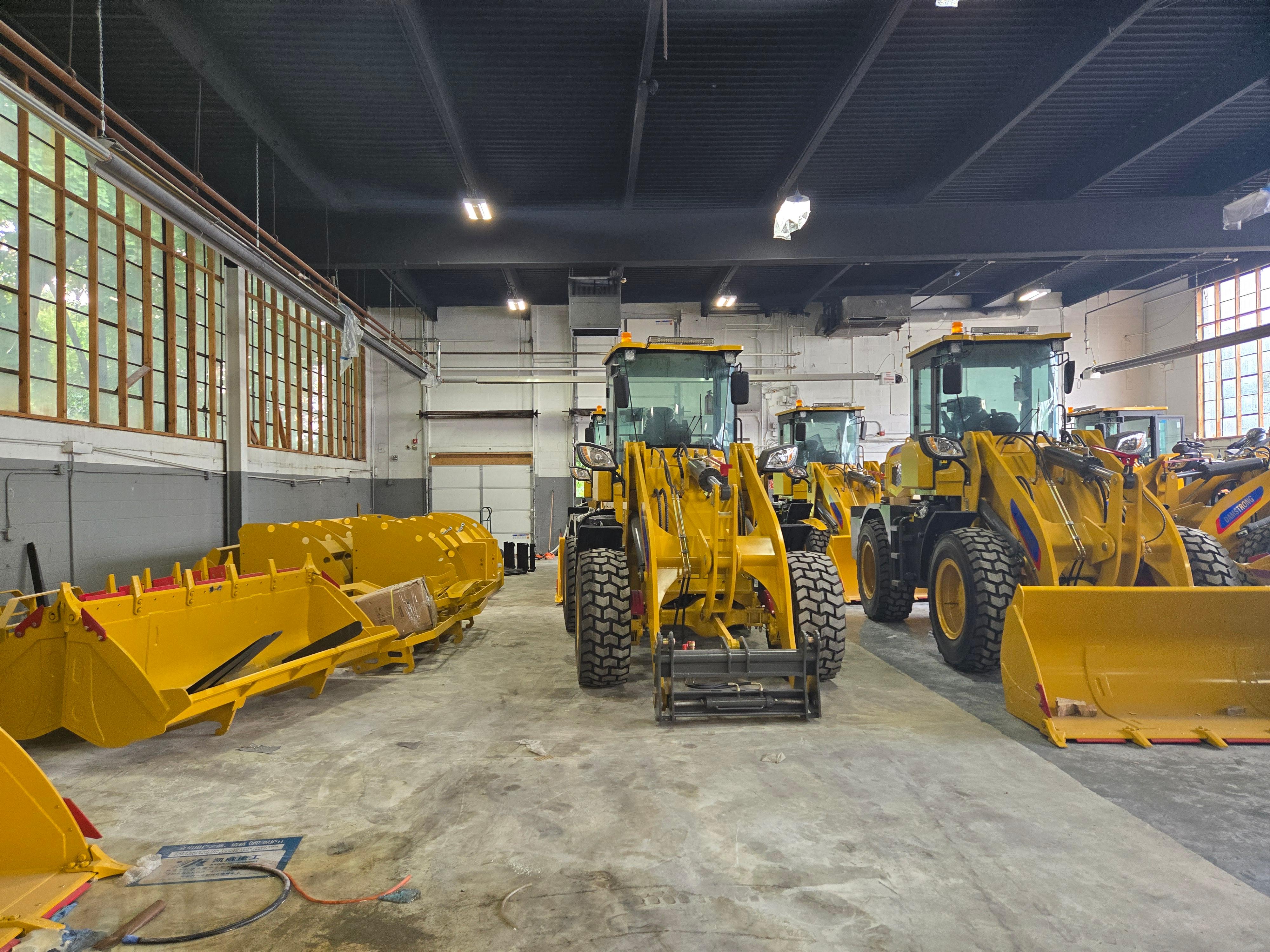 Wheel loaders in a warehouse attachments to the left