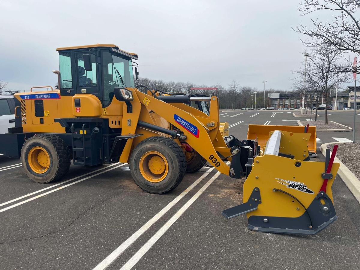 Damstrong wheel loader with snow pusher attachment
