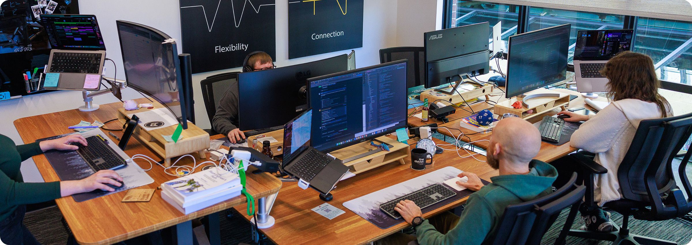 Twenty Ideas tech team members working at computers in their office