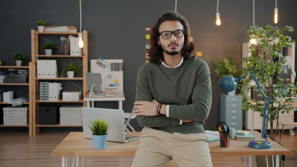 Business owner in an office weighing up doing AI himself versus hiring an AI consultant in NZ