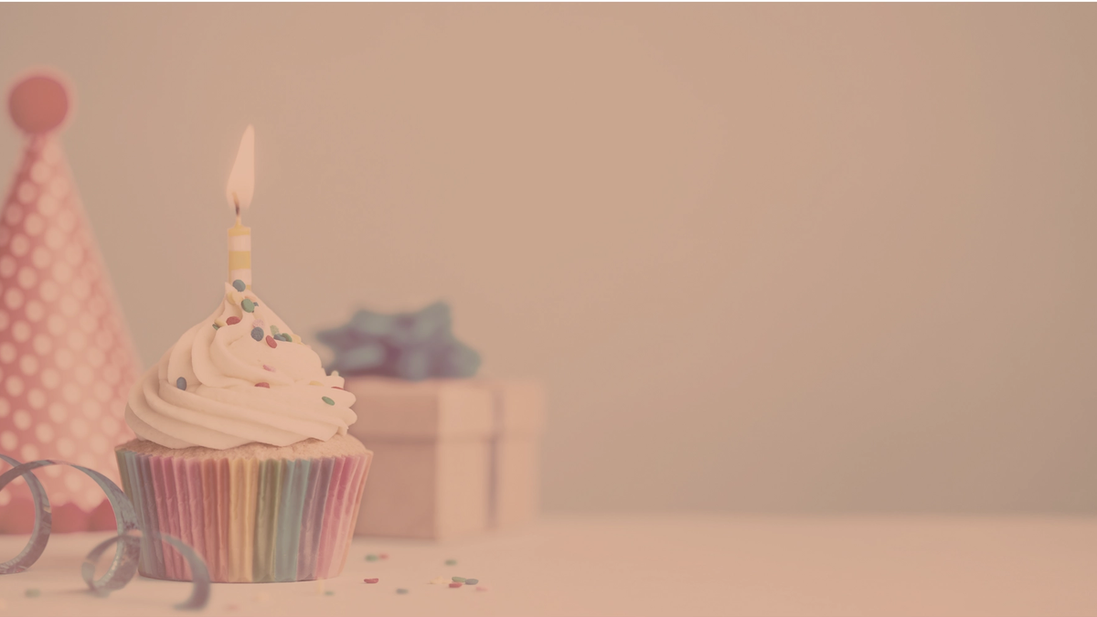 Photo of a cupcake, present, and birthday hat