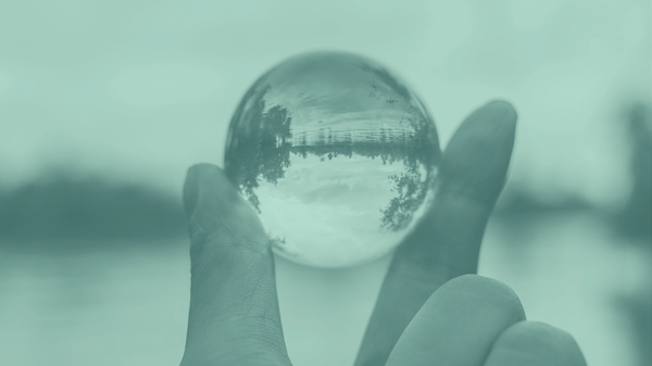 A photo of fingers holding a crystal ball