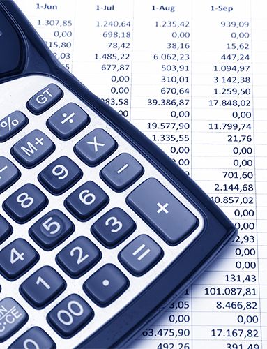 a calculator is sitting on top of a table with a pen .