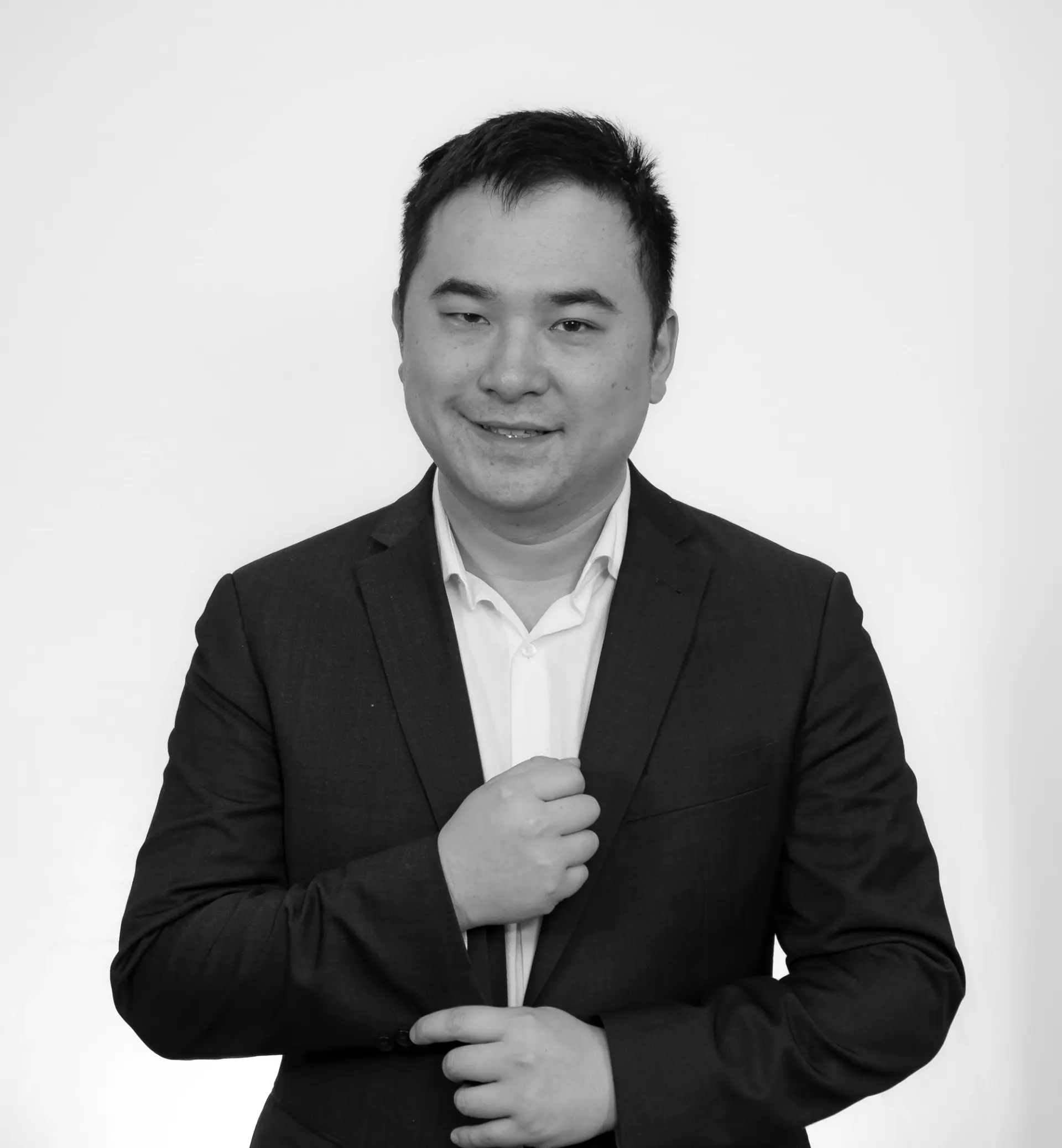 a black and white photo of a man in a suit