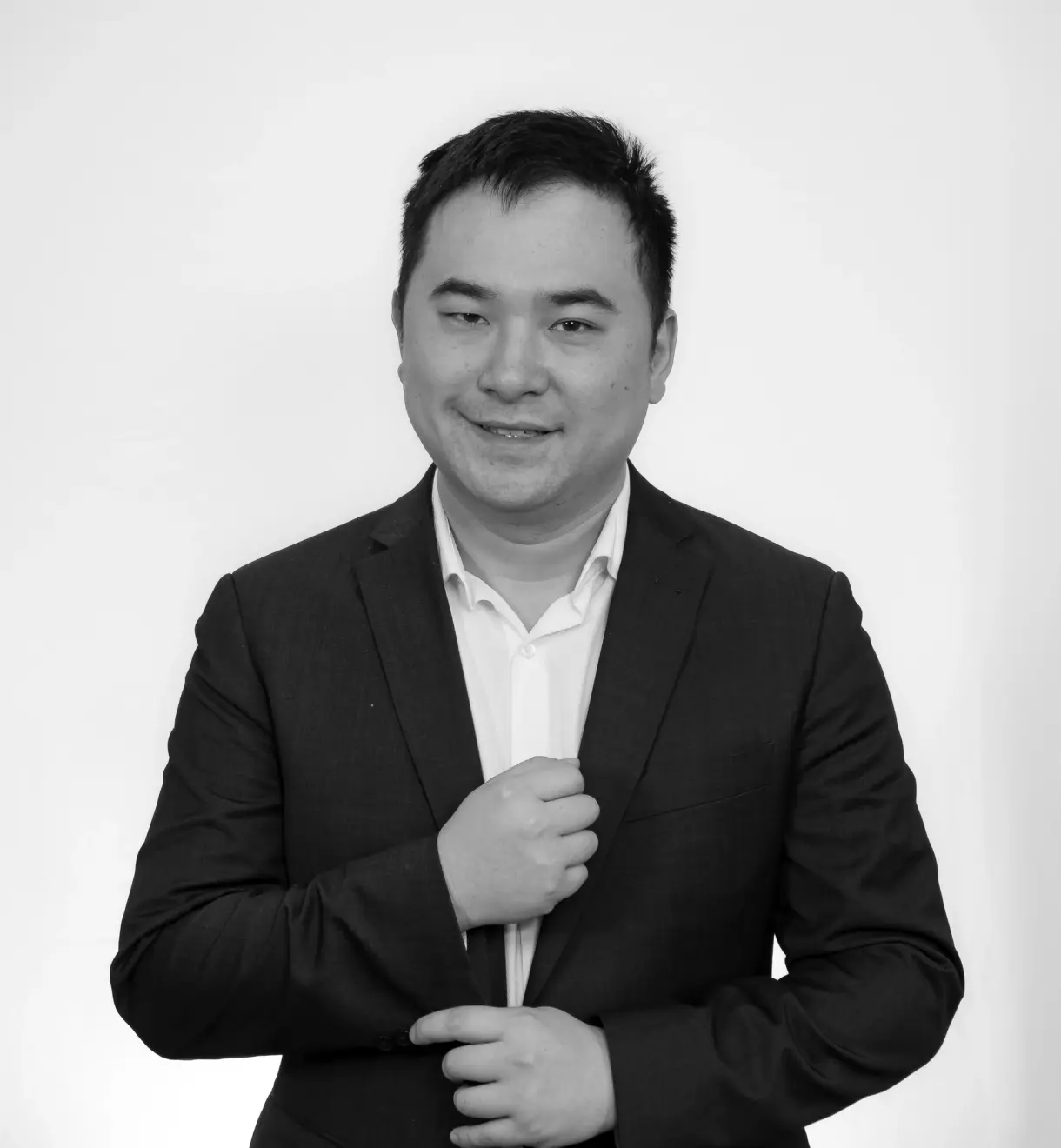 a black and white photo of a man in a suit