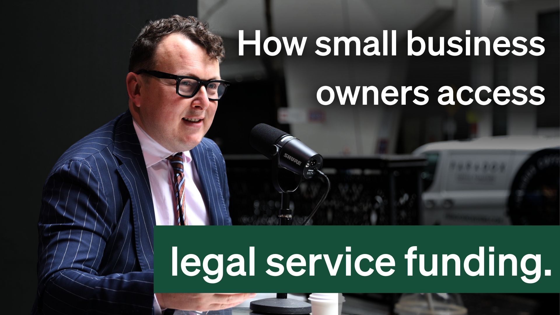 A man in a suit speaks into a microphone with text "How small business owners access legal service funding."