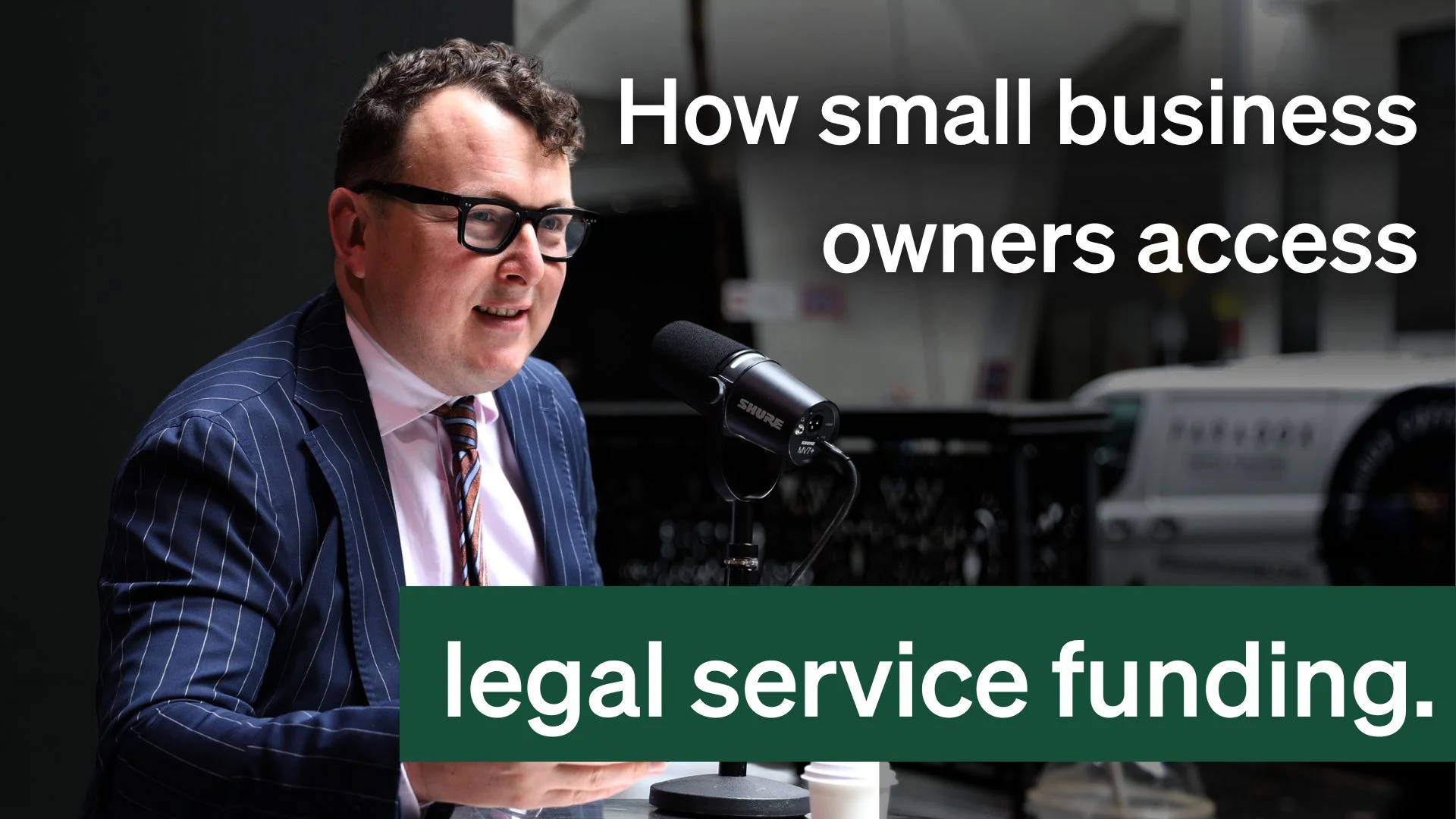 A man in a suit speaks into a microphone with text "How small business owners access legal service funding."