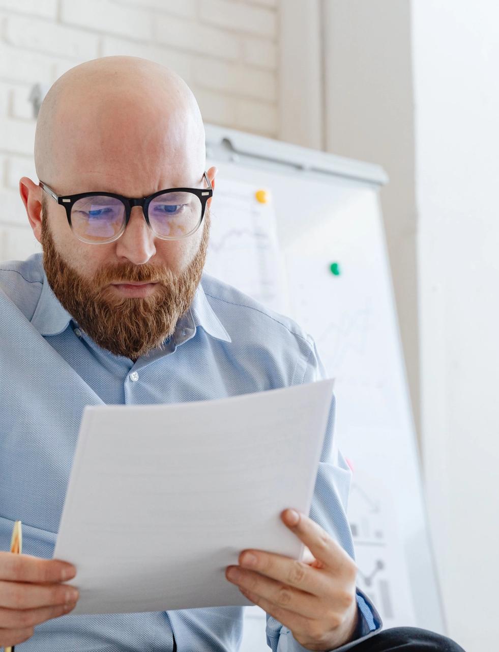 A bankruptcy trustee reviewing a personal insolvency report in his office