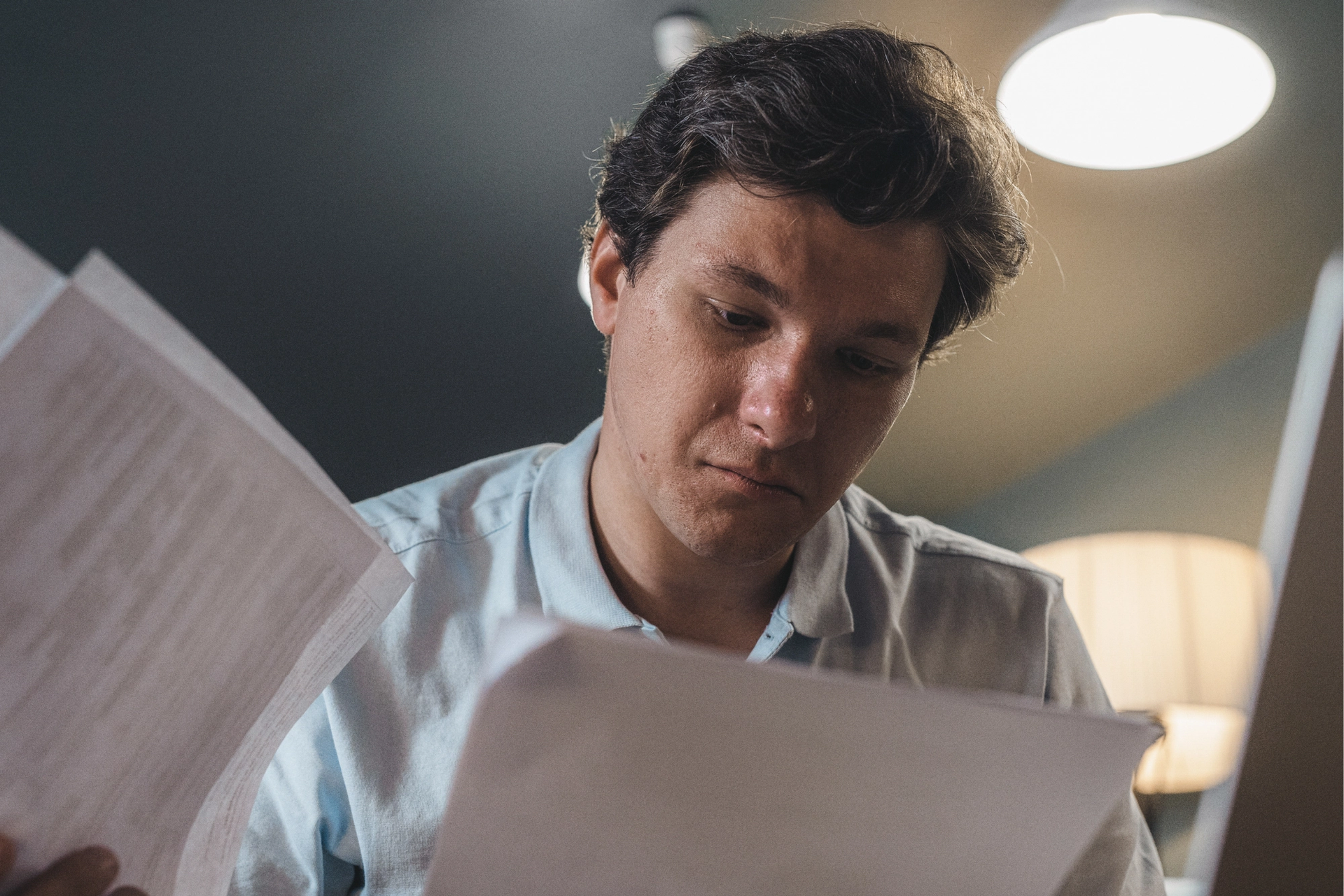 Man intently reviewing documents.
