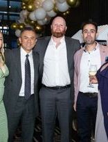 a group of people are posing for a picture at a party .