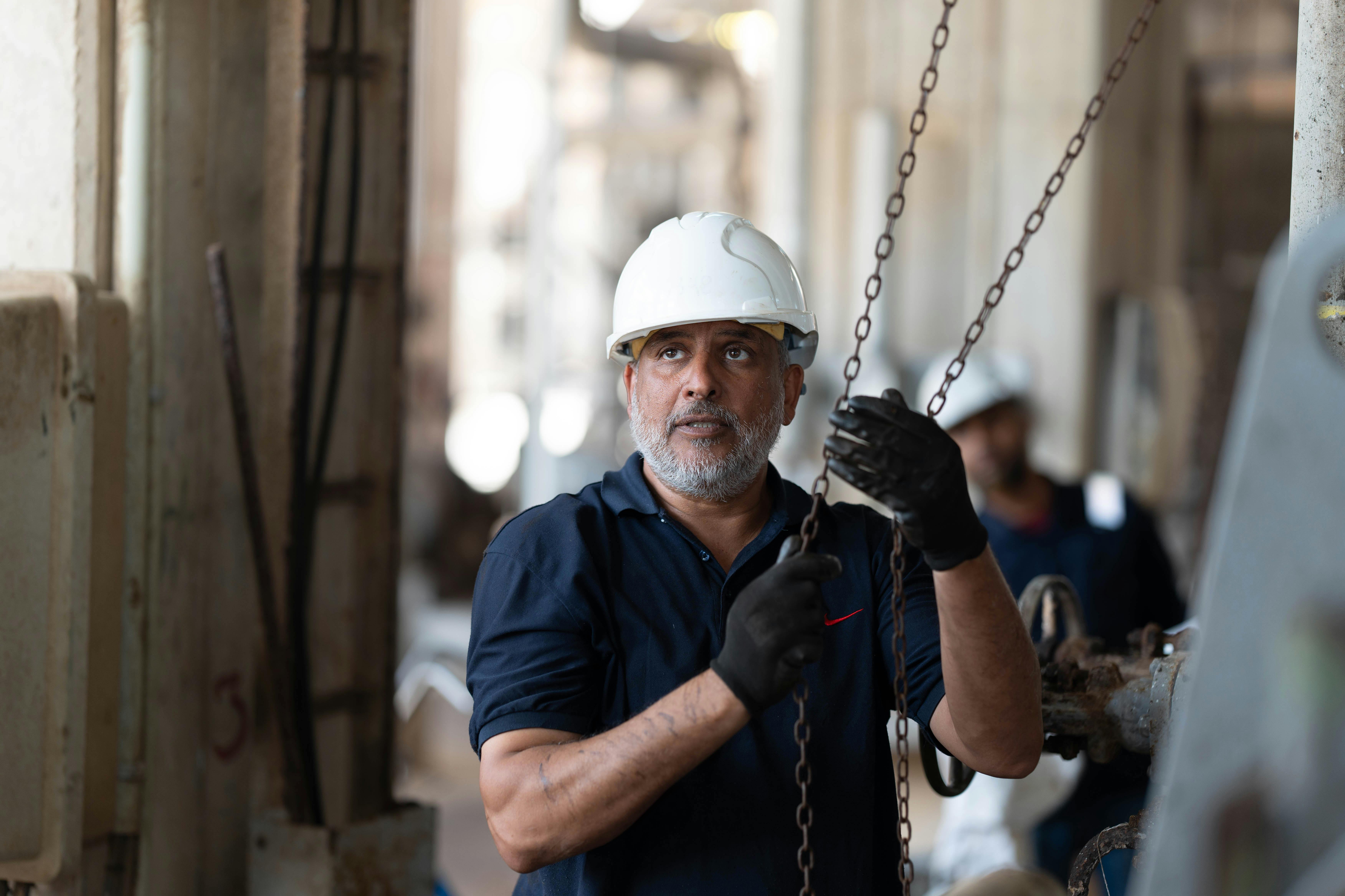 A bearded man in a white hard hat and work gloves holds chains, looking up in an industrial facility.​​​​‌﻿‍﻿​‍​‍‌‍﻿﻿‌﻿​‍‌‍‍‌‌‍‌﻿‌‍‍‌‌‍﻿‍​‍​‍​﻿‍‍​‍​‍‌﻿​﻿‌‍​‌‌‍﻿‍‌‍‍‌‌﻿‌​‌﻿‍‌​‍﻿‍‌‍‍‌‌‍﻿﻿​‍​‍​‍﻿​​‍​‍‌‍‍​‌﻿​‍‌‍‌‌‌‍‌‍​‍​‍​﻿‍‍​‍​‍‌‍‍​‌﻿‌​‌﻿‌​‌﻿​​‌﻿​﻿​﻿‍‍​‍﻿﻿​‍﻿﻿‌‍﻿‌‌‍​‌‌‍​﻿‌‍‍﻿‌‍​‌‌﻿‍‌​‍﻿‌‌‍‌﻿‌‍﻿﻿‌‍﻿﻿‌‍‌​‌﻿‌﻿‌‍‍‌‌‍﻿‍​‍﻿‍‌﻿​﻿‌‍​‌‌‍﻿‍‌‍‍‌‌﻿‌​‌﻿‍‌​‍﻿‍‌﻿​﻿‌﻿‌​‌﻿‌‌‌‍‌​‌‍‍‌‌‍﻿﻿​‍﻿﻿‌﻿​﻿‌﻿‌​‌﻿‌‌‌‍‌​‌‍‍‌‌‍﻿﻿​‍﻿﻿‌‍‍‌‌‍﻿‍‌﻿‌​‌‍‌‌‌‍﻿‍‌﻿‌​​‍﻿﻿‌‍‌‌‌‍‌​‌‍‍‌‌﻿‌​​‍﻿﻿‌‍﻿‌‌‍﻿﻿‌‍‌​‌‍‌‌​﻿﻿‌‌﻿​​‌﻿​‍‌‍‌‌‌﻿​﻿‌‍‌‌‌‍﻿‍‌﻿‌​‌‍​‌‌﻿‌​‌‍‍‌‌‍﻿﻿‌‍﻿‍​﻿‍﻿‌‍‍‌‌‍‌​​﻿﻿‌‌‍‌‌‌‍‌​‌‍‌​​﻿‍‌‌‍​‌‌‍​﻿‌‍‌‌‌‍‌‍​‍﻿‌​﻿​﻿​﻿‌‍​﻿​​​﻿​​​‍﻿‌​﻿‌​‌‍‌​‌‍‌​‌‍‌‍​‍﻿‌​﻿‍​​﻿​﻿​﻿‍​​﻿​﻿​‍﻿‌‌‍​‍​﻿‌‌​﻿‍​‌‍‌​​﻿‌‍​﻿​​‌‍​‍‌‍‌​​﻿‌‍‌‍​﻿‌‍‌‌‌‍​‌​﻿‍﻿‌﻿‌​‌﻿‍‌‌﻿​​‌‍‌‌​﻿﻿‌‌﻿​​‌‍﻿﻿‌﻿​﻿‌﻿‌​​﻿‍﻿‌﻿​​‌‍​‌‌﻿‌​‌‍‍​​﻿﻿‌‌‍‍‌‌‍﻿‌‌‍​‌‌‍‌﻿‌‍‌‌​‍﻿‍‌‍​‌‌‍﻿​‌﻿‌​​﻿﻿﻿‌‍​‍‌‍​‌‌﻿​﻿‌‍‌‌‌‌‌‌‌﻿​‍‌‍﻿​​﻿﻿‌‌‍‍​‌﻿‌​‌﻿‌​‌﻿​​‌﻿​﻿​‍‌‌​﻿​﻿‌​​‌​‍‌‌​﻿​‍‌​‌‍​‍‌‌​﻿​‍‌​‌‍‌‍﻿‌‌‍​‌‌‍​﻿‌‍‍﻿‌‍​‌‌﻿‍‌​‍﻿‌‌‍‌﻿‌‍﻿﻿‌‍﻿﻿‌‍‌​‌﻿‌﻿‌‍‍‌‌‍﻿‍​‍﻿‍‌﻿​﻿‌‍​‌‌‍﻿‍‌‍‍‌‌﻿‌​‌﻿‍‌​‍﻿‍‌﻿​﻿‌﻿‌​‌﻿‌‌‌‍‌​‌‍‍‌‌‍﻿﻿​‍‌‌​﻿​‍‌​‌‍‌﻿​﻿‌﻿‌​‌﻿‌‌‌‍‌​‌‍‍‌‌‍﻿﻿​‍‌‍‌‍‍‌‌‍‌​​﻿﻿‌‌‍‌‌‌‍‌​‌‍‌​​﻿‍‌‌‍​‌‌‍​﻿‌‍‌‌‌‍‌‍​‍﻿‌​﻿​﻿​﻿‌‍​﻿​​​﻿​​​‍﻿‌​﻿‌​‌‍‌​‌‍‌​‌‍‌‍​‍﻿‌​﻿‍​​﻿​﻿​﻿‍​​﻿​﻿​‍﻿‌‌‍​‍​﻿‌‌​﻿‍​‌‍‌​​﻿‌‍​﻿​​‌‍​‍‌‍‌​​﻿‌‍‌‍​﻿‌‍‌‌‌‍​‌​‍‌‍‌﻿‌​‌﻿‍‌‌﻿​​‌‍‌‌​﻿﻿‌‌﻿​​‌‍﻿﻿‌﻿​﻿‌﻿‌​​‍‌‍‌﻿​​‌‍​‌‌﻿‌​‌‍‍​​﻿﻿‌‌‍‍‌‌‍﻿‌‌‍​‌‌‍‌﻿‌‍‌‌​‍﻿‍‌‍​‌‌‍﻿​‌﻿‌​​‍‌‍‌﻿​​‌‍‌‌‌﻿​‍‌﻿​﻿‌﻿​​‌‍‌‌‌‍​﻿‌﻿‌​‌‍‍‌‌﻿‌‍‌‍‌‌​﻿﻿‌‌﻿​​‌﻿‌‌‌‍​‍‌‍﻿​‌‍‍‌‌﻿​﻿‌‍‍​‌‍‌‌‌‍‌​​‍​‍‌﻿﻿‌