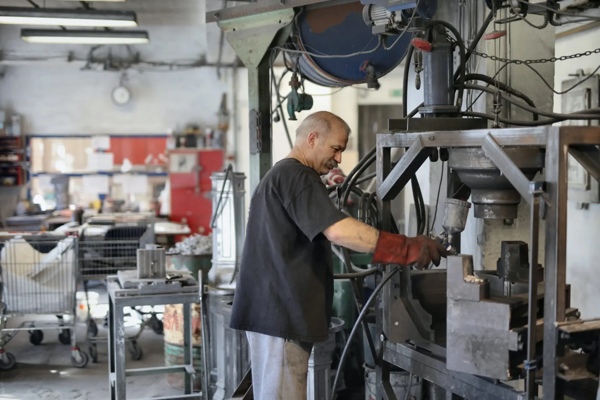 a man is working on a machine in a factory .
