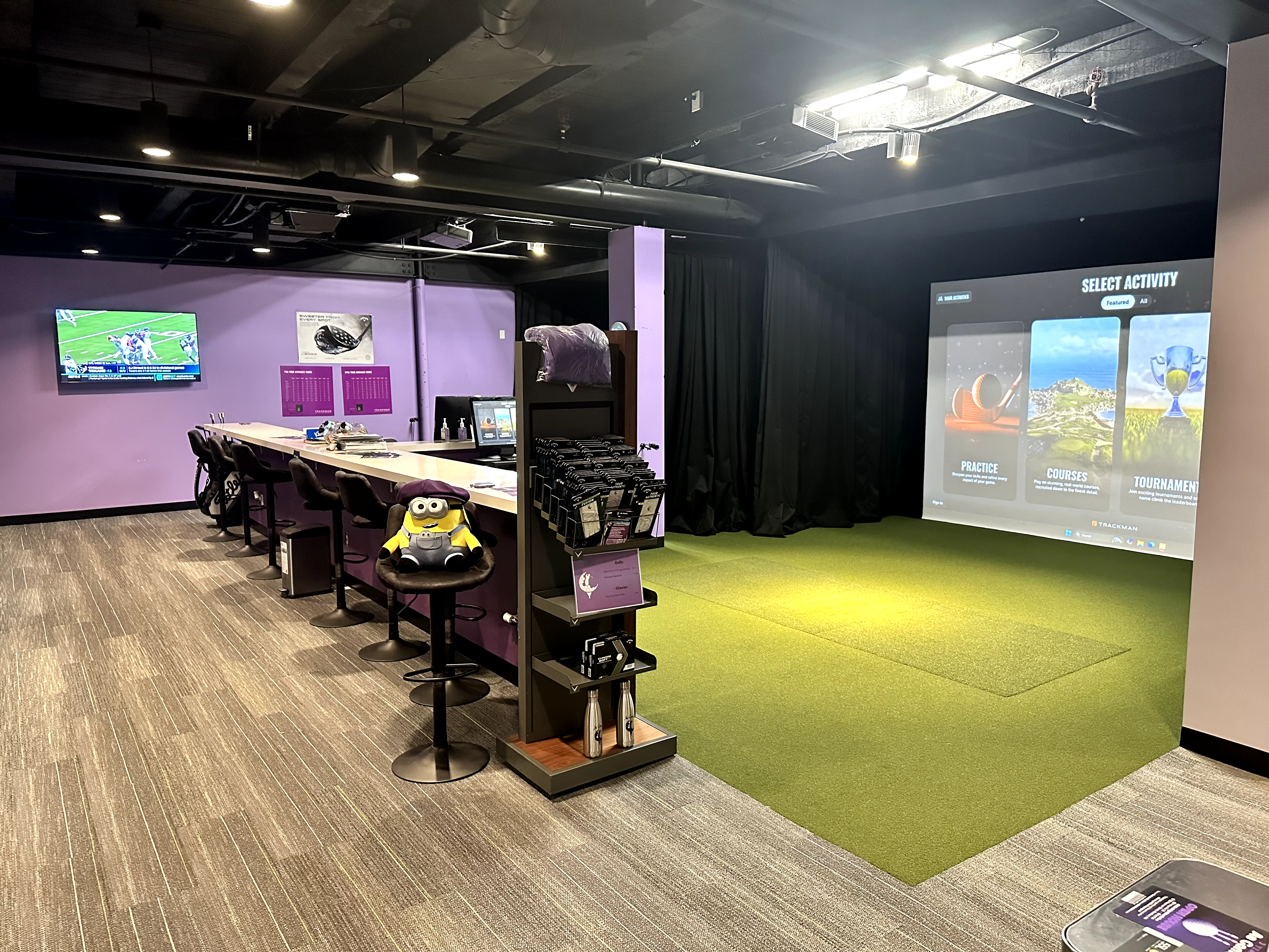 Indoor golf simulator bay for member practice.