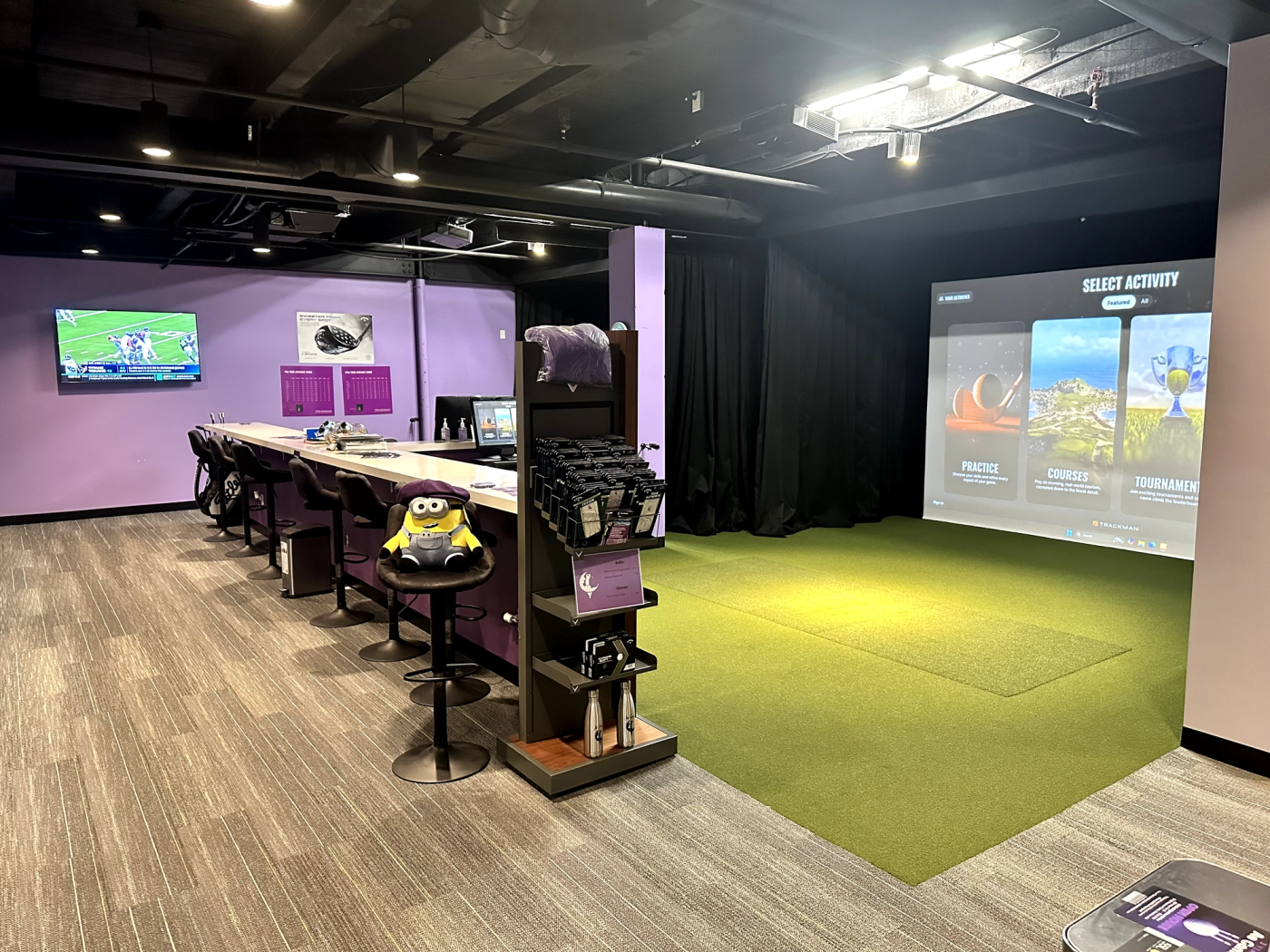 Indoor golf lounge and simulator bays at Ae Game Golf.