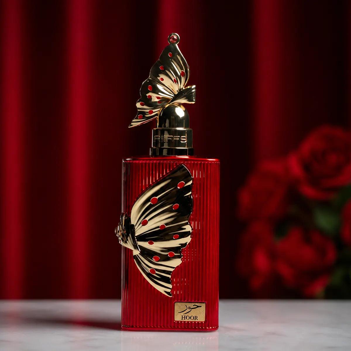 Riiffs Hoor 100ML perfume bottle beside red roses