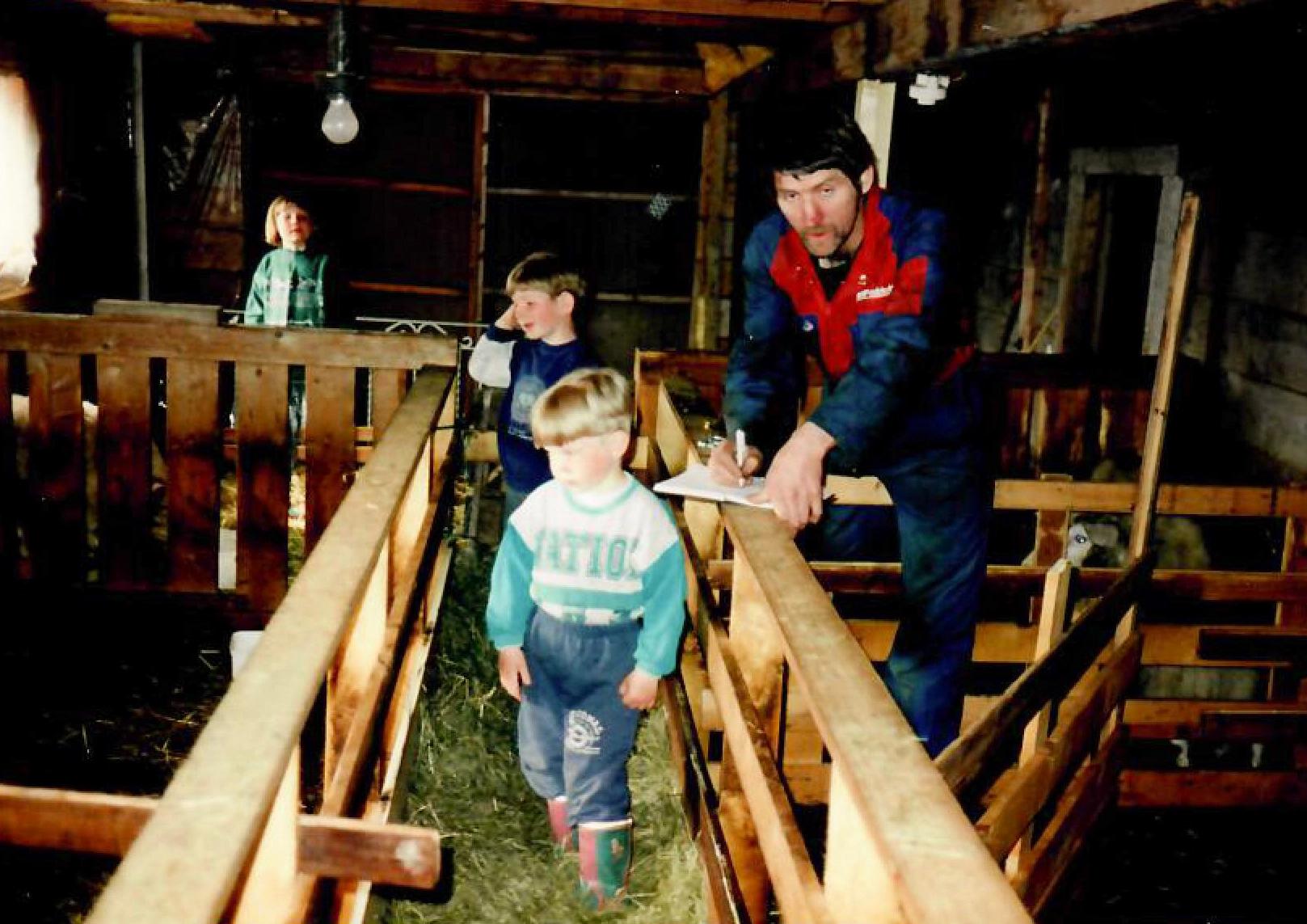 Torbjørn and his children inside the barn barn building
