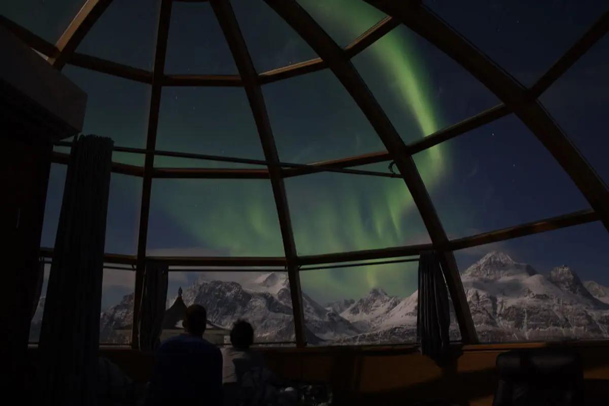 Northern lights seen from inside a 360º glass igloo at Lyngen North