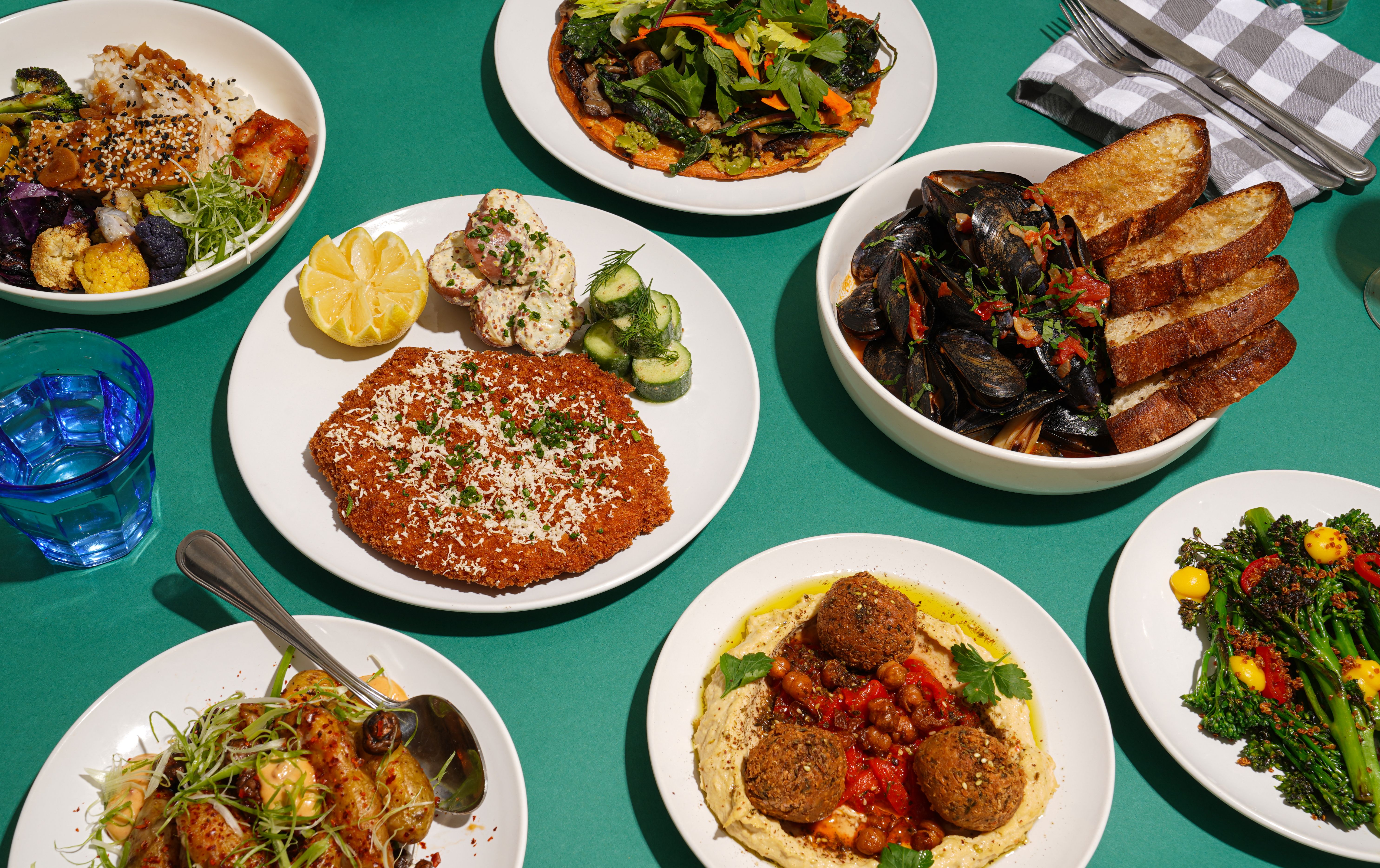 Mussels, Falafel and other dish on a green table.