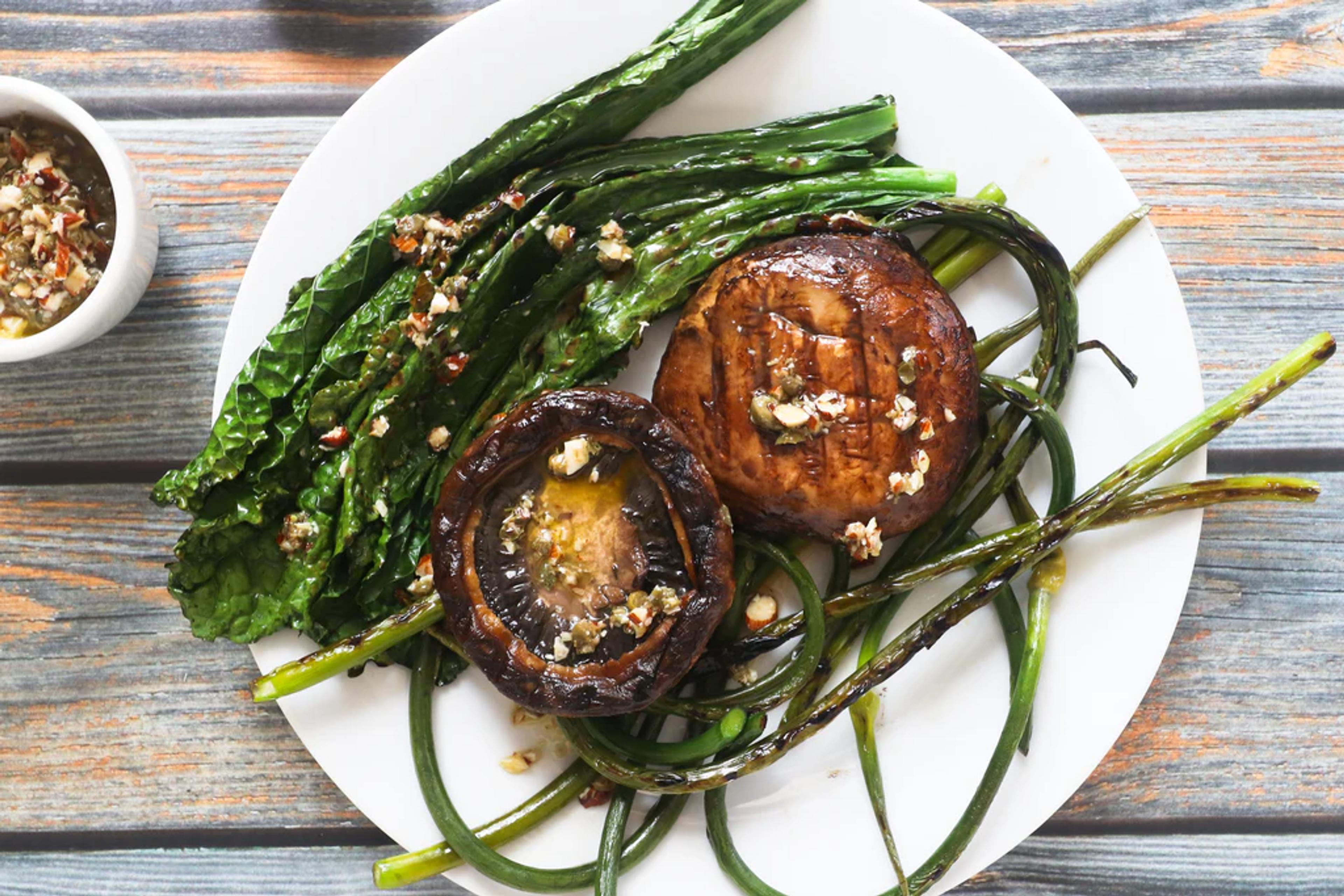 Grilled Portobello Caps with Garlic Scapes, Kale and Almond Caper Sauce