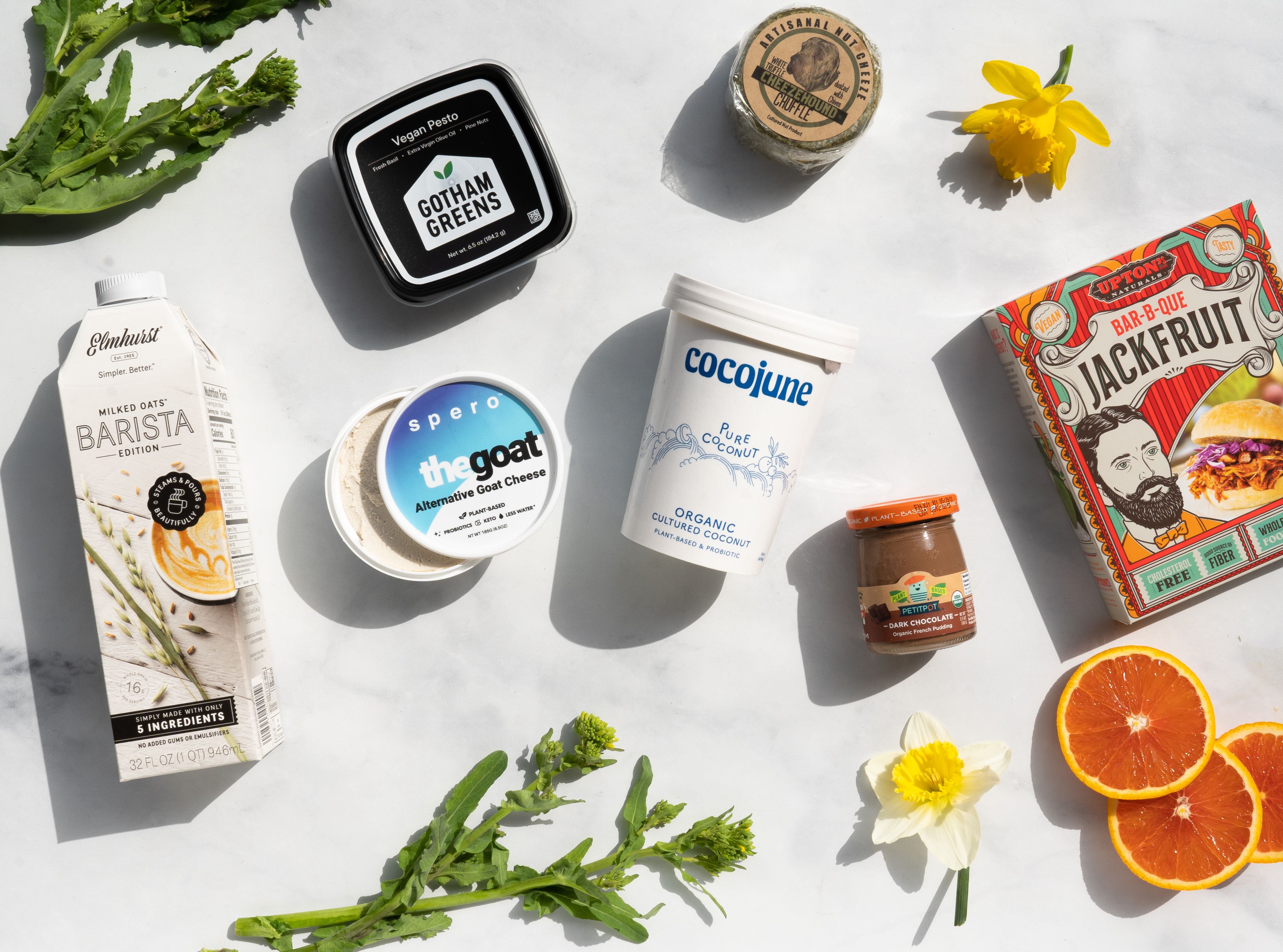 Local food products laid flat on a white marble background