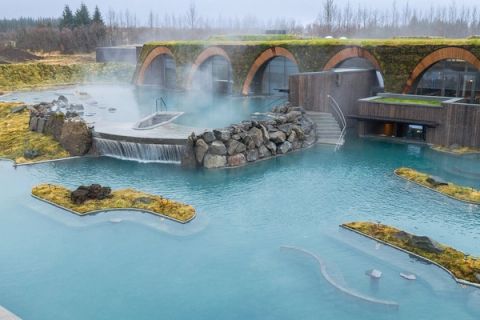 Laugarás Lagoon geothermal pools and waterfall in South Iceland