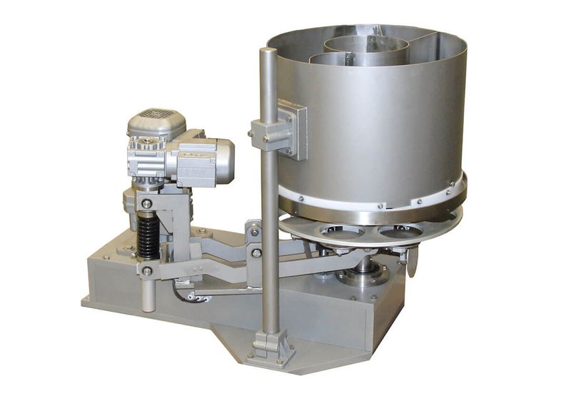 A Hastamat doser portioning free-flowing product into containers.