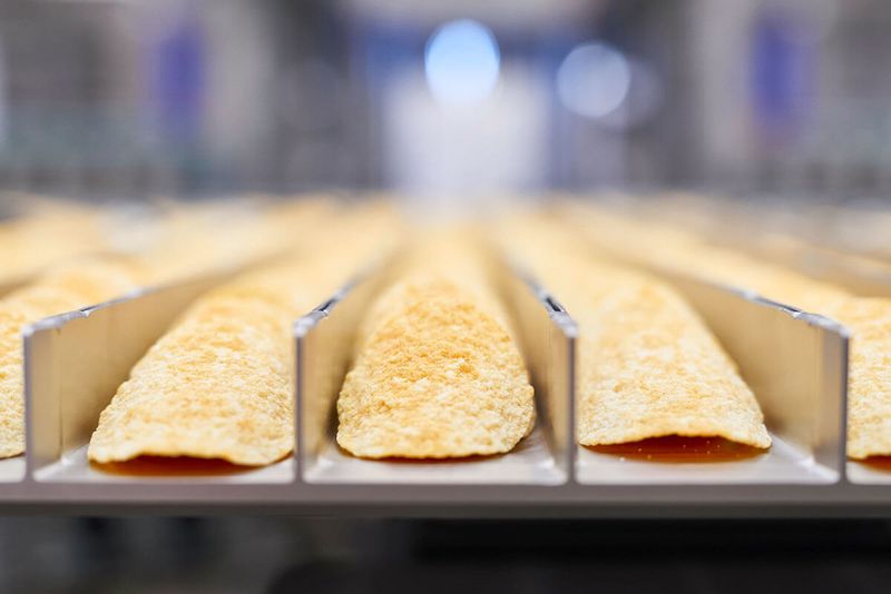 A Hastamat line running stackable chips from weighing through to finished bags.