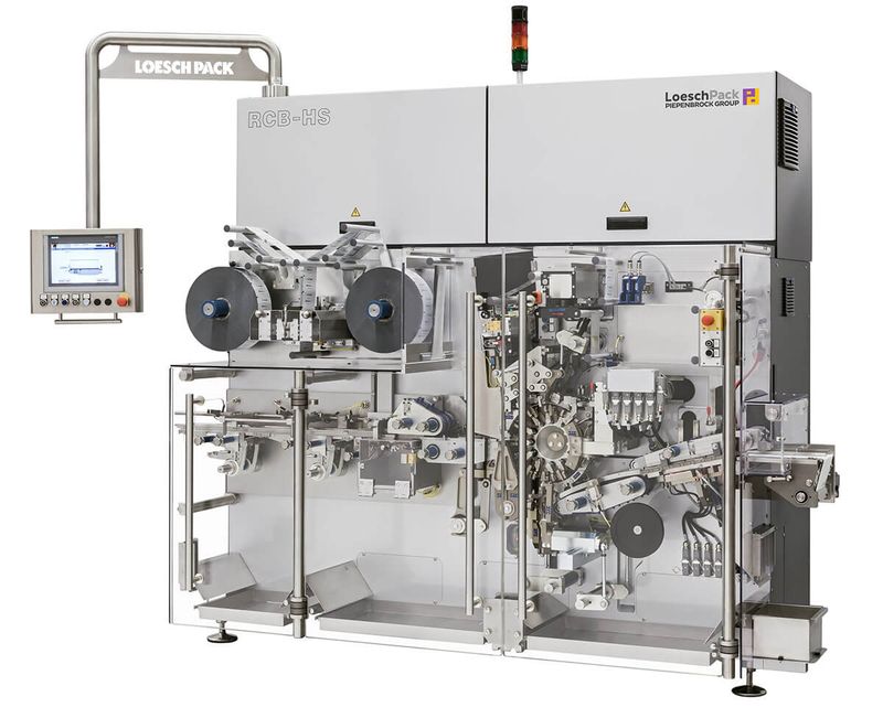 A LoeschPack RCB fold wrapping machine closing a folded outer wrap.
