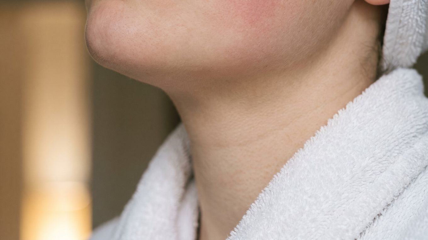 Skin below the cheek with a soft flush from heat after a hot shower or sauna