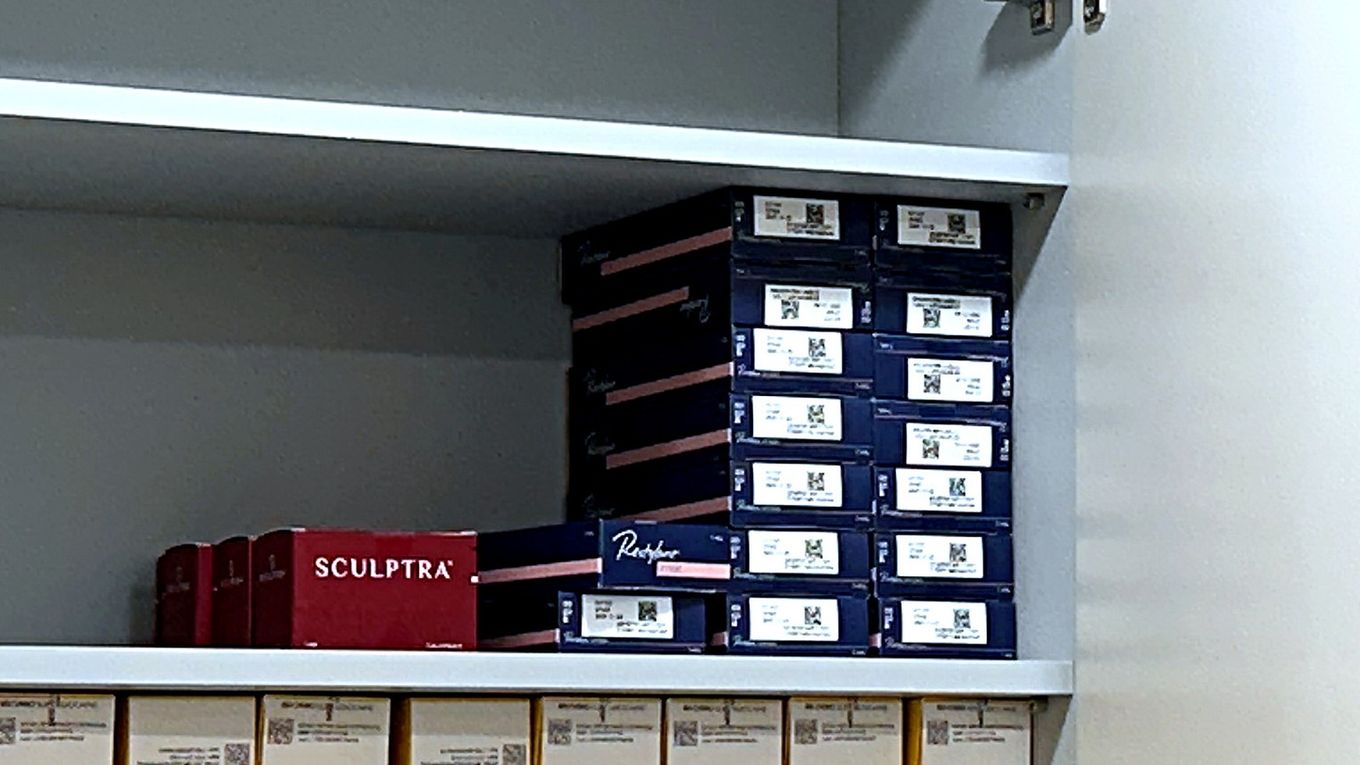 Genuine Sculptra boxes in the storage cabinet at our Myeongdong clinic, alongside other genuine filler products with their QR labels visible