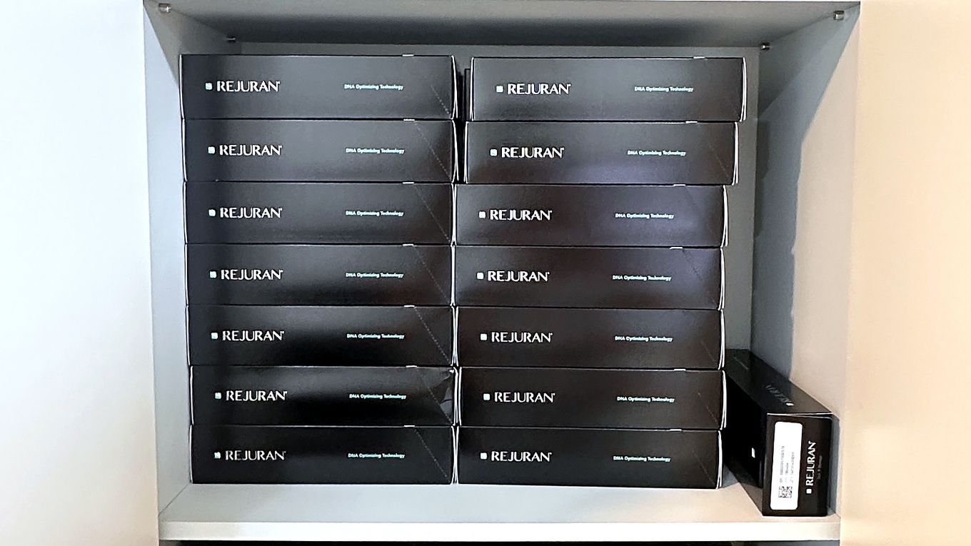 Genuine Rejuran boxes stacked in the storage cabinet at our clinic in Myeongdong; which product was used is a variable that can be confirmed from records