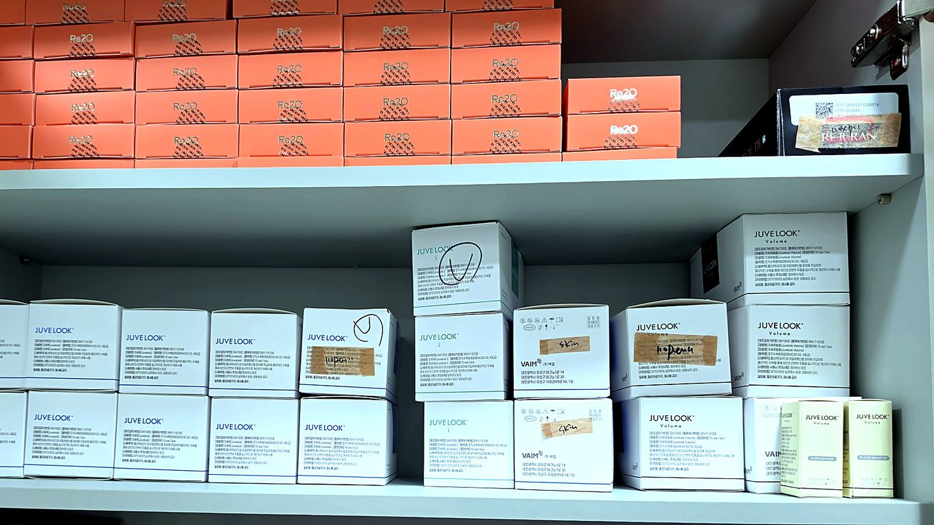 Genuine collagen-booster boxes such as Rejuran and Juvelook lined up with their labels visible in the storage cabinet at our Myeongdong clinic