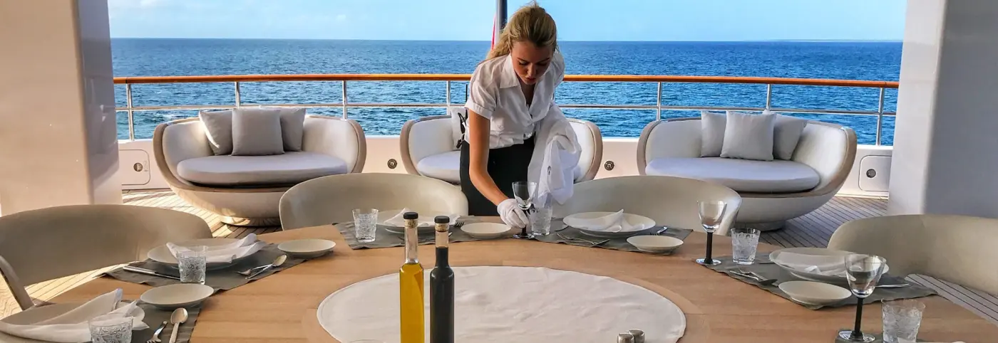 Table set for dinner on a luxury charter yacht deck in Greece