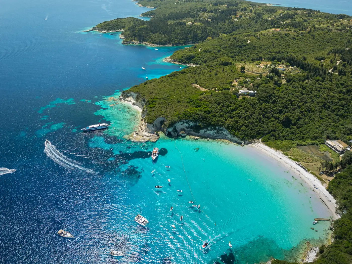 Turquoise bay with sailing yachts at anchor off Antipaxos in the Ionian islands, Greece, seen from above. Photo by ShotsBy Csongii, Pexels 38014996
