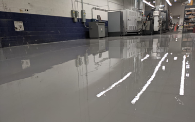 Chemically-resistant epoxy floor under factory machinery