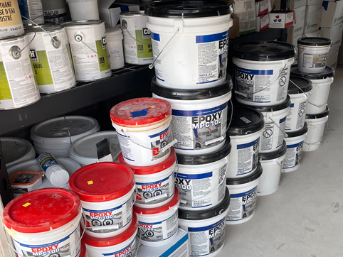 Epoxy product containers in a warehouse