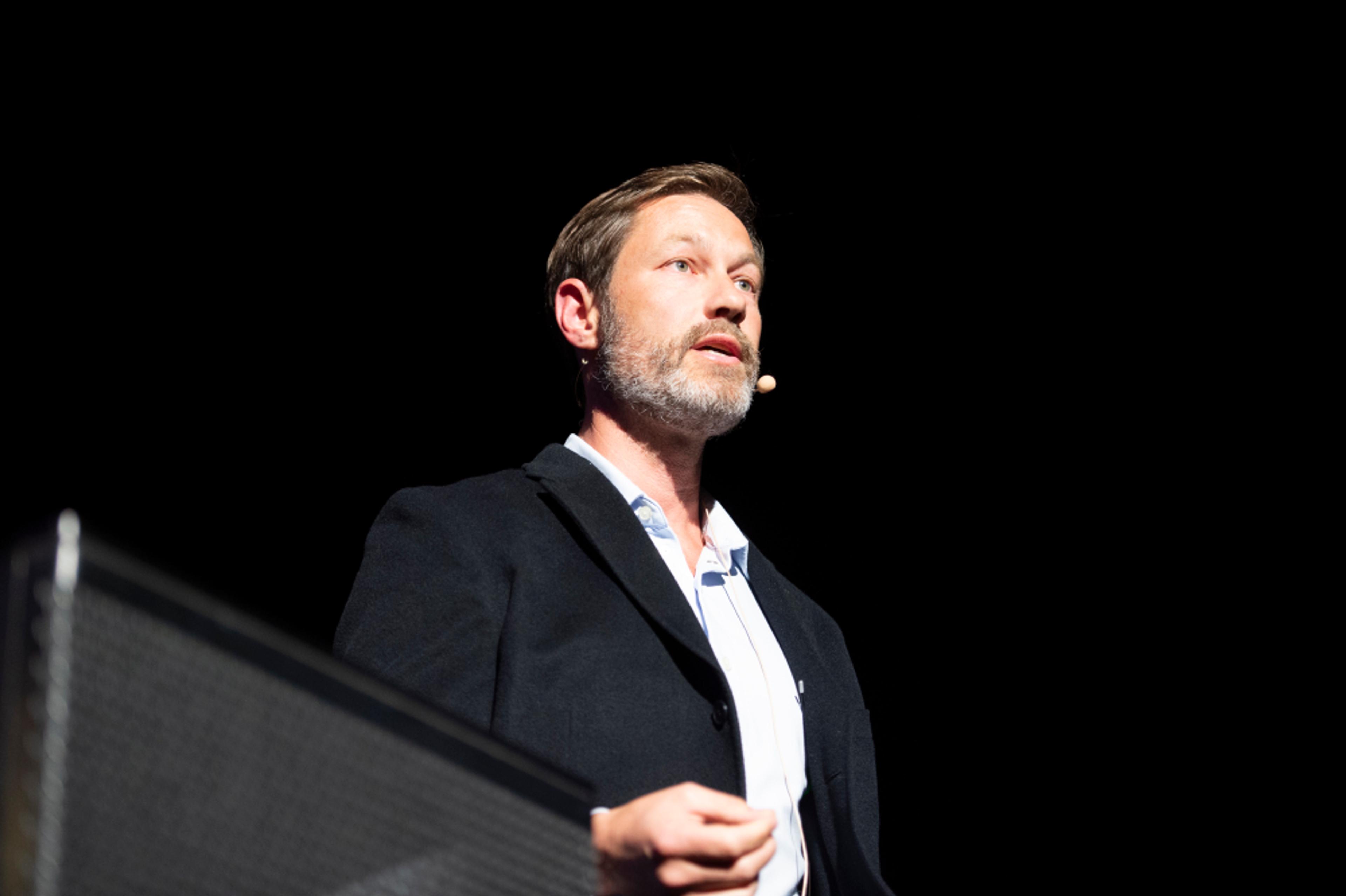 Dr. Lowan Stewart speaking at a conference