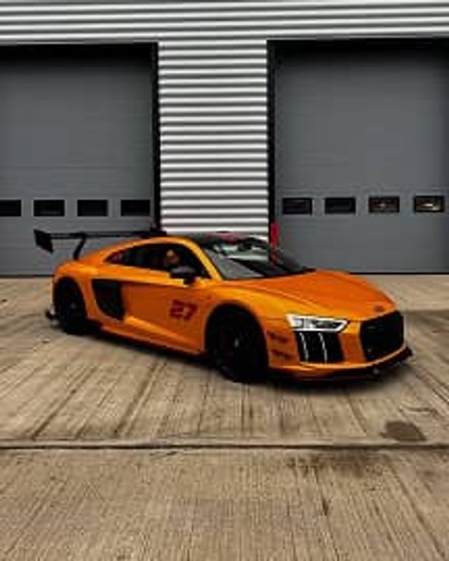 Audio R8 in orange outside the warehouse