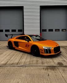 Audio R8 in orange outside the warehouse