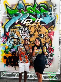 Two people smiling and holding energy drink cans in front of a vibrant graffiti wall.​​​​‌﻿‍﻿​‍​‍‌‍﻿﻿‌﻿​‍‌‍‍‌‌‍‌﻿‌‍‍‌‌‍﻿‍​‍​‍​﻿‍‍​‍​‍‌﻿​﻿‌‍​‌‌‍﻿‍‌‍‍‌‌﻿‌​‌﻿‍‌​‍﻿‍‌‍‍‌‌‍﻿﻿​‍​‍​‍﻿​​‍​‍‌‍‍​‌﻿​‍‌‍‌‌‌‍‌‍​‍​‍​﻿‍‍​‍​‍‌‍‍​‌﻿‌​‌﻿‌​‌﻿​​‌﻿​﻿​﻿‍‍​‍﻿﻿​‍﻿﻿‌﻿‌﻿‌﻿‌﻿‌﻿‌﻿​‍﻿‍‌﻿​‍‌‍‍‌‌﻿​​‌‍‍‌‌﻿‌​‌‍‌‌‌‍﻿‍‌‍‌‌‌﻿​‍‌‍‌﻿‌﻿‍‌​‍﻿‍‌‍​﻿‌‍﻿﻿‌‍﻿‌​‍﻿﻿‌‍‍‌‌‍﻿‍‌﻿‌​‌‍‌‌‌‍﻿‍‌﻿‌​​‍﻿﻿‌‍‌‌‌‍‌​‌‍‍‌‌﻿‌​​‍﻿﻿‌‍﻿‌‌‍﻿﻿‌‍‌​‌‍‌‌​﻿﻿‌‌﻿​​‌﻿​‍‌‍‌‌‌﻿​﻿‌‍‌‌‌‍﻿‍‌﻿‌​‌‍​‌‌﻿‌​‌‍‍‌‌‍﻿﻿‌‍﻿‍​﻿‍﻿‌‍‍‌‌‍‌​​﻿﻿‌​﻿​‍‌‍‌​​﻿​﻿​﻿​‌​﻿‌﻿​﻿‌‍‌‍​‌​﻿‍​​‍﻿‌​﻿​‍​﻿‍​‌‍​﻿​﻿‌​​‍﻿‌​﻿‌​​﻿​​​﻿‌‌​﻿‌‌​‍﻿‌​﻿‍​​﻿‍​​﻿‌​​﻿​​​‍﻿‌​﻿‌﻿‌‍‌​​﻿‌​‌‍​﻿​﻿​﻿​﻿‌‌‌‍​‍‌‍​‌​﻿‌‌‌‍​‌‌‍‌​‌‍​‌​﻿‍﻿‌﻿‌​‌﻿‍‌‌﻿​​‌‍‌‌​﻿﻿‌‌‍﻿‌‌‍﻿﻿‌‍‌​‌﻿‌‌‌‍﻿​‌‍‌‌​﻿‍﻿‌﻿​​‌‍​‌‌﻿‌​‌‍‍​​﻿﻿‌‌﻿‌‍‌‍‌‌‌﻿​‍‌﻿‌​‌‍‍‌‌‍​﻿‌‍​‌‌‍﻿​‌​﻿‌‌‍​‌‌﻿​‍‌﻿​‌‌﻿‌‌‌‍‌‌‌‍‌‌​‍﻿‍‌‍‍‌‌‍﻿‌‌‍​‌‌‍‌﻿‌‍‌‌‌﻿​﻿​‍‌‌​﻿‌‌‌​​‍‌‌﻿﻿‌‍‍﻿‌‍‌‌‌﻿‍‌​‍‌‌​﻿​﻿‌​‌​​‍‌‌​﻿​﻿‌​‌​​‍‌‌​﻿​‍​﻿​‍‌‍​‌‌‍​‌‌‍‌‌​﻿‌‌​﻿​﻿​﻿​‌‌‍‌‌‌‍‌‌​﻿‌​​﻿‍​​﻿‌‌‌‍​﻿​‍‌‌​﻿​‍​﻿​‍​‍‌‌​﻿‌‌‌​‌​​‍﻿‍‌‍‍‌‌‍﻿‌‌‍​‌‌‍‌﻿‌‍‌‌​‍﻿‍‌‍​‌‌‍﻿​‌﻿‌​​﻿﻿﻿‌‍​‍‌‍​‌‌﻿​﻿‌‍‌‌‌‌‌‌‌﻿​‍‌‍﻿​​﻿﻿‌‌‍‍​‌﻿‌​‌﻿‌​‌﻿​​‌﻿​﻿​‍‌‌​﻿​﻿‌​​‌​‍‌‌​﻿​‍‌​‌‍​‍‌‌​﻿​‍‌​‌‍‌﻿‌﻿‌﻿‌﻿‌﻿‌﻿​‍﻿‍‌﻿​‍‌‍‍‌‌﻿​​‌‍‍‌‌﻿‌​‌‍‌‌‌‍﻿‍‌‍‌‌‌﻿​‍‌‍‌﻿‌﻿‍‌​‍﻿‍‌‍​﻿‌‍﻿﻿‌‍﻿‌​‍‌‍‌‍‍‌‌‍‌​​﻿﻿‌​﻿​‍‌‍‌​​﻿​﻿​﻿​‌​﻿‌﻿​﻿‌‍‌‍​‌​﻿‍​​‍﻿‌​﻿​‍​﻿‍​‌‍​﻿​﻿‌​​‍﻿‌​﻿‌​​﻿​​​﻿‌‌​﻿‌‌​‍﻿‌​﻿‍​​﻿‍​​﻿‌​​﻿​​​‍﻿‌​﻿‌﻿‌‍‌​​﻿‌​‌‍​﻿​﻿​﻿​﻿‌‌‌‍​‍‌‍​‌​﻿‌‌‌‍​‌‌‍‌​‌‍​‌​‍‌‍‌﻿‌​‌﻿‍‌‌﻿​​‌‍‌‌​﻿﻿‌‌‍﻿‌‌‍﻿﻿‌‍‌​‌﻿‌‌‌‍﻿​‌‍‌‌​‍‌‍‌﻿​​‌‍​‌‌﻿‌​‌‍‍​​﻿﻿‌‌﻿‌‍‌‍‌‌‌﻿​‍‌﻿‌​‌‍‍‌‌‍​﻿‌‍​‌‌‍﻿​‌​﻿‌‌‍​‌‌﻿​‍‌﻿​‌‌﻿‌‌‌‍‌‌‌‍‌‌​‍﻿‍‌‍‍‌‌‍﻿‌‌‍​‌‌‍‌﻿‌‍‌‌‌﻿​﻿​‍‌‌​﻿‌‌‌​​‍‌‌﻿﻿‌‍‍﻿‌‍‌‌‌﻿‍‌​‍‌‌​﻿​﻿‌​‌​​‍‌‌​﻿​﻿‌​‌​​‍‌‌​﻿​‍​﻿​‍‌‍​‌‌‍​‌‌‍‌‌​﻿‌‌​﻿​﻿​﻿​‌‌‍‌‌‌‍‌‌​﻿‌​​﻿‍​​﻿‌‌‌‍​﻿​‍‌‌​﻿​‍​﻿​‍​‍‌‌​﻿‌‌‌​‌​​‍﻿‍‌‍‍‌‌‍﻿‌‌‍​‌‌‍‌﻿‌‍‌‌​‍﻿‍‌‍​‌‌‍﻿​‌﻿‌​​‍​‍‌﻿﻿‌