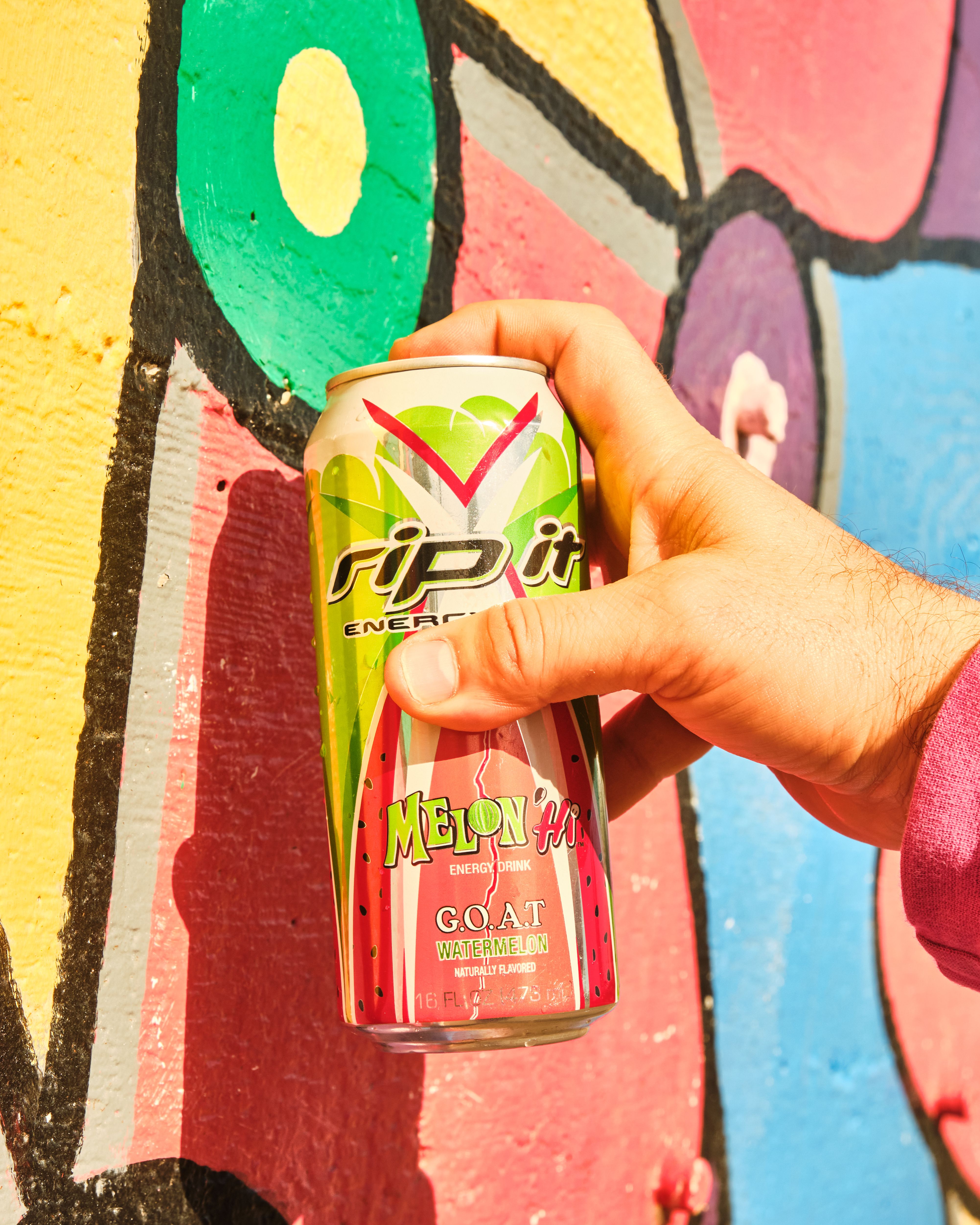 Hand holding a Rip It Melon Hi energy drink can against a colorful mural.​​​​‌﻿‍﻿​‍​‍‌‍﻿﻿‌﻿​‍‌‍‍‌‌‍‌﻿‌‍‍‌‌‍﻿‍​‍​‍​﻿‍‍​‍​‍‌﻿​﻿‌‍​‌‌‍﻿‍‌‍‍‌‌﻿‌​‌﻿‍‌​‍﻿‍‌‍‍‌‌‍﻿﻿​‍​‍​‍﻿​​‍​‍‌‍‍​‌﻿​‍‌‍‌‌‌‍‌‍​‍​‍​﻿‍‍​‍​‍‌‍‍​‌﻿‌​‌﻿‌​‌﻿​​‌﻿​﻿​﻿‍‍​‍﻿﻿​‍﻿﻿‌﻿‌﻿‌﻿‌﻿‌﻿‌﻿​‍﻿‍‌﻿​‍‌‍‍‌‌﻿​​‌‍‍‌‌﻿‌​‌‍‌‌‌‍﻿‍‌‍‌‌‌﻿​‍‌‍‌﻿‌﻿‍‌​‍﻿‍‌‍​﻿‌‍﻿﻿‌‍﻿‌​‍﻿﻿‌‍‍‌‌‍﻿‍‌﻿‌​‌‍‌‌‌‍﻿‍‌﻿‌​​‍﻿﻿‌‍‌‌‌‍‌​‌‍‍‌‌﻿‌​​‍﻿﻿‌‍﻿‌‌‍﻿﻿‌‍‌​‌‍‌‌​﻿﻿‌‌﻿​​‌﻿​‍‌‍‌‌‌﻿​﻿‌‍‌‌‌‍﻿‍‌﻿‌​‌‍​‌‌﻿‌​‌‍‍‌‌‍﻿﻿‌‍﻿‍​﻿‍﻿‌‍‍‌‌‍‌​​﻿﻿‌‌‍​‌​﻿‌​​﻿​‍‌‍​‌​﻿‌﻿​﻿​​​﻿‍​​﻿‌‌​‍﻿‌​﻿​﻿​﻿‌‌​﻿​​​﻿​‍​‍﻿‌​﻿‌​​﻿​​​﻿‌​​﻿​‍​‍﻿‌‌‍​‌‌‍​‌‌‍‌‌‌‍‌‍​‍﻿‌​﻿​​​﻿​‌‌‍​‍‌‍‌‌​﻿​﻿​﻿‌​​﻿‍‌​﻿‌​‌‍​﻿​﻿‍​‌‍‌‍‌‍‌​​﻿‍﻿‌﻿‌​‌﻿‍‌‌﻿​​‌‍‌‌​﻿﻿‌‌‍﻿‌‌‍﻿﻿‌‍‌​‌﻿‌‌‌‍﻿​‌‍‌‌​﻿‍﻿‌﻿​​‌‍​‌‌﻿‌​‌‍‍​​﻿﻿‌‌‍​﻿‌‍​‌‌﻿​‍‌‍‌​‌‌​﻿‌‍​﻿‌﻿​‍‌‍﻿﻿‌‍﻿​‌‍﻿​​‍﻿‍‌﻿‌​‌‍﻿﻿‌﻿​​‌‌﻿﻿‌﻿​﻿‌‍​﻿‌﻿​‍‌‍﻿﻿‌‍﻿​‌‍﻿​​‍‌‌​﻿‌‌‌​​‍‌‌﻿﻿‌‍‍﻿‌‍‌‌‌﻿‍‌​‍‌‌​﻿​﻿‌​‌​​‍‌‌​﻿​﻿‌​‌​​‍‌‌​﻿​‍​﻿​‍​﻿​‌​﻿​‍‌‍‌‍​﻿‌﻿​﻿‍‌​﻿​﻿‌‍‌‌​﻿‍‌​﻿​﻿​﻿​‍​﻿‌‍​﻿‍‌​‍‌‌​﻿​‍​﻿​‍​‍‌‌​﻿‌‌‌​‌​​‍﻿‍‌‍‍‌‌‍﻿‌‌‍​‌‌‍‌﻿‌‍‌‌​‍﻿‍‌‍​‌‌‍﻿​‌﻿‌​​﻿﻿﻿‌‍​‍‌‍​‌‌﻿​﻿‌‍‌‌‌‌‌‌‌﻿​‍‌‍﻿​​﻿﻿‌‌‍‍​‌﻿‌​‌﻿‌​‌﻿​​‌﻿​﻿​‍‌‌​﻿​﻿‌​​‌​‍‌‌​﻿​‍‌​‌‍​‍‌‌​﻿​‍‌​‌‍‌﻿‌﻿‌﻿‌﻿‌﻿‌﻿​‍﻿‍‌﻿​‍‌‍‍‌‌﻿​​‌‍‍‌‌﻿‌​‌‍‌‌‌‍﻿‍‌‍‌‌‌﻿​‍‌‍‌﻿‌﻿‍‌​‍﻿‍‌‍​﻿‌‍﻿﻿‌‍﻿‌​‍‌‍‌‍‍‌‌‍‌​​﻿﻿‌‌‍​‌​﻿‌​​﻿​‍‌‍​‌​﻿‌﻿​﻿​​​﻿‍​​﻿‌‌​‍﻿‌​﻿​﻿​﻿‌‌​﻿​​​﻿​‍​‍﻿‌​﻿‌​​﻿​​​﻿‌​​﻿​‍​‍﻿‌‌‍​‌‌‍​‌‌‍‌‌‌‍‌‍​‍﻿‌​﻿​​​﻿​‌‌‍​‍‌‍‌‌​﻿​﻿​﻿‌​​﻿‍‌​﻿‌​‌‍​﻿​﻿‍​‌‍‌‍‌‍‌​​‍‌‍‌﻿‌​‌﻿‍‌‌﻿​​‌‍‌‌​﻿﻿‌‌‍﻿‌‌‍﻿﻿‌‍‌​‌﻿‌‌‌‍﻿​‌‍‌‌​‍‌‍‌﻿​​‌‍​‌‌﻿‌​‌‍‍​​﻿﻿‌‌‍​﻿‌‍​‌‌﻿​‍‌‍‌​‌‌​﻿‌‍​﻿‌﻿​‍‌‍﻿﻿‌‍﻿​‌‍﻿​​‍﻿‍‌﻿‌​‌‍﻿﻿‌﻿​​‌‌﻿﻿‌﻿​﻿‌‍​﻿‌﻿​‍‌‍﻿﻿‌‍﻿​‌‍﻿​​‍‌‌​﻿‌‌‌​​‍‌‌﻿﻿‌‍‍﻿‌‍‌‌‌﻿‍‌​‍‌‌​﻿​﻿‌​‌​​‍‌‌​﻿​﻿‌​‌​​‍‌‌​﻿​‍​﻿​‍​﻿​‌​﻿​‍‌‍‌‍​﻿‌﻿​﻿‍‌​﻿​﻿‌‍‌‌​﻿‍‌​﻿​﻿​﻿​‍​﻿‌‍​﻿‍‌​‍‌‌​﻿​‍​﻿​‍​‍‌‌​﻿‌‌‌​‌​​‍﻿‍‌‍‍‌‌‍﻿‌‌‍​‌‌‍‌﻿‌‍‌‌​‍﻿‍‌‍​‌‌‍﻿​‌﻿‌​​‍​‍‌﻿﻿‌