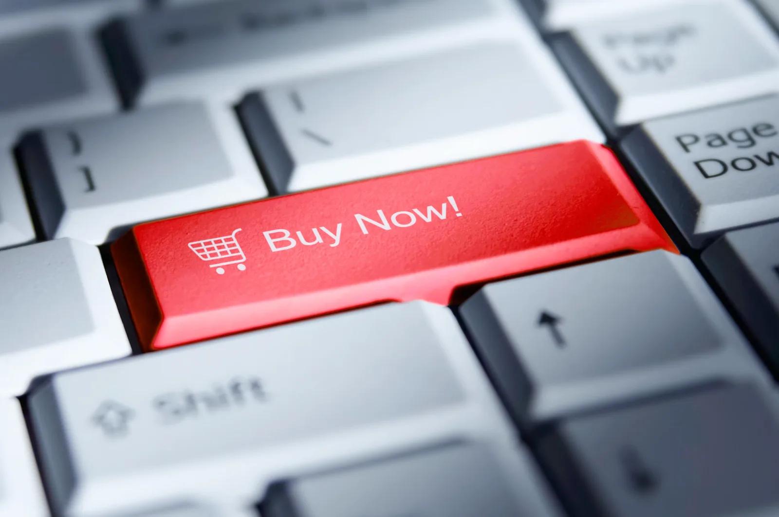 A red "Buy Now!" key with a shopping cart icon, standing out on an otherwise plain computer keyboard