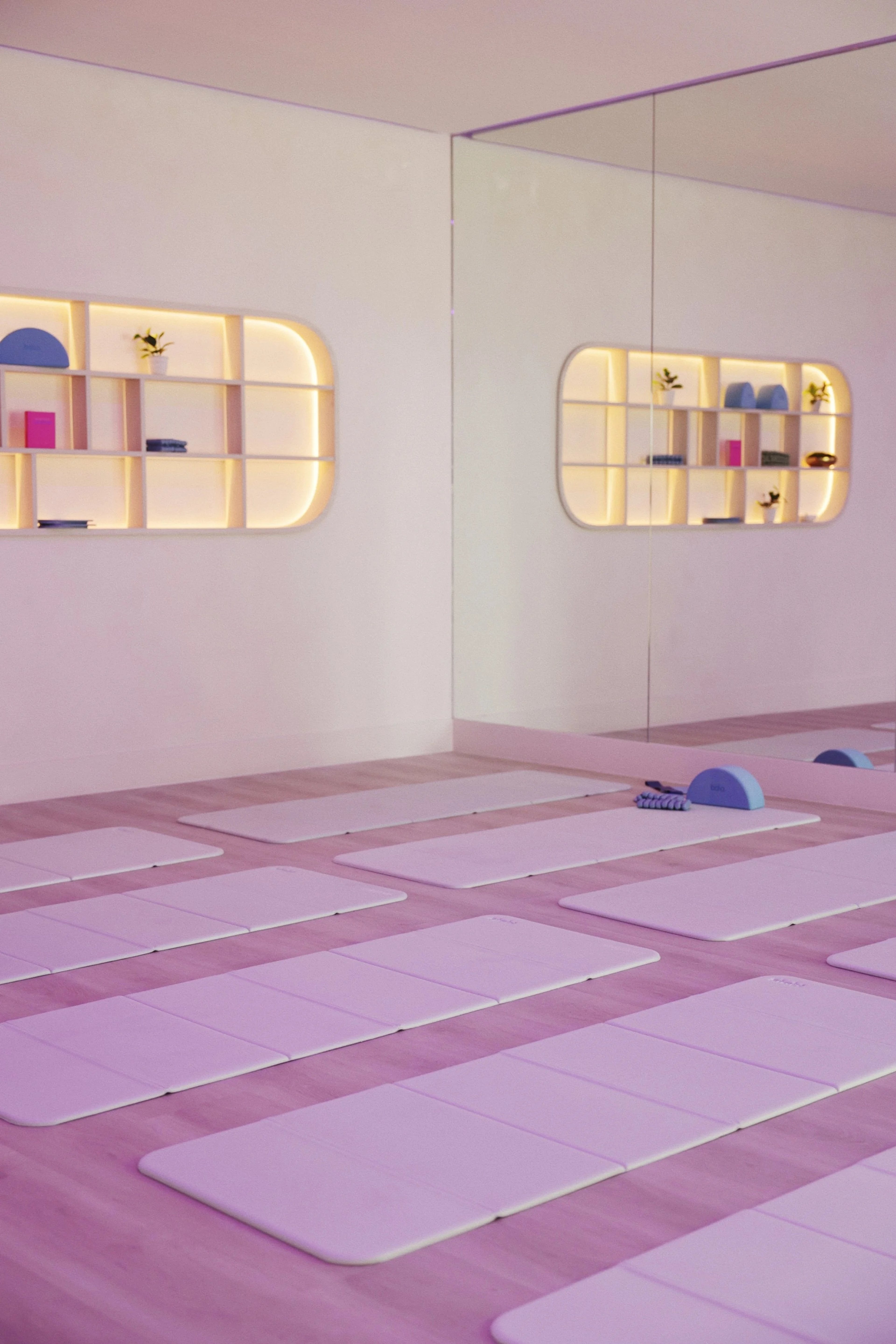 Lilac mats and rounded prop shelves in the Daily Flows Studio practice room
