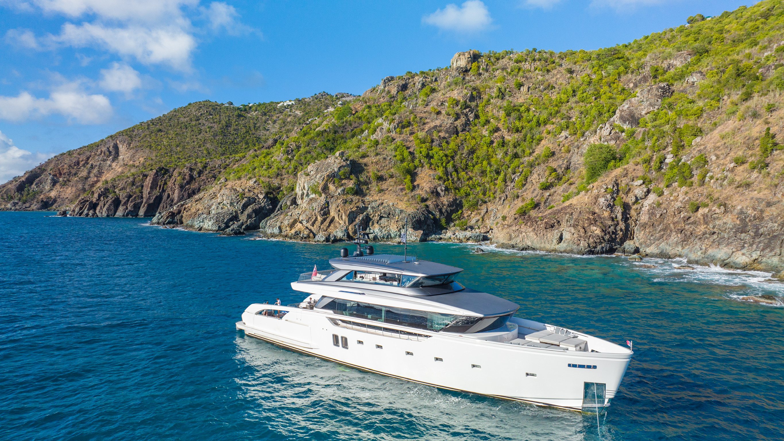 Sun loungers on the bow of the yacht with two guests
